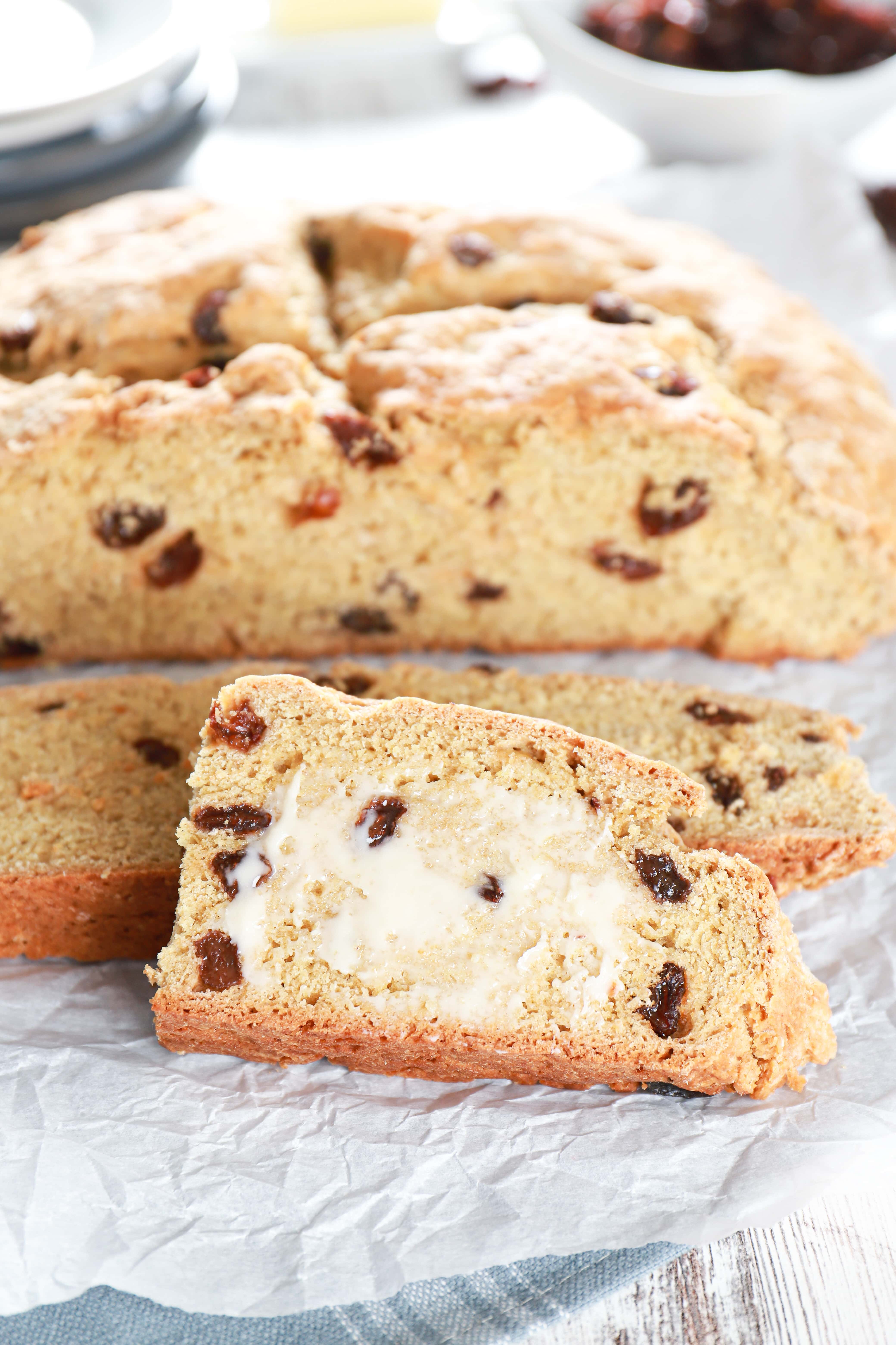 Slices of Irish Soda Bread with the loaf in the background. Recipe from A Kitchen Addiction