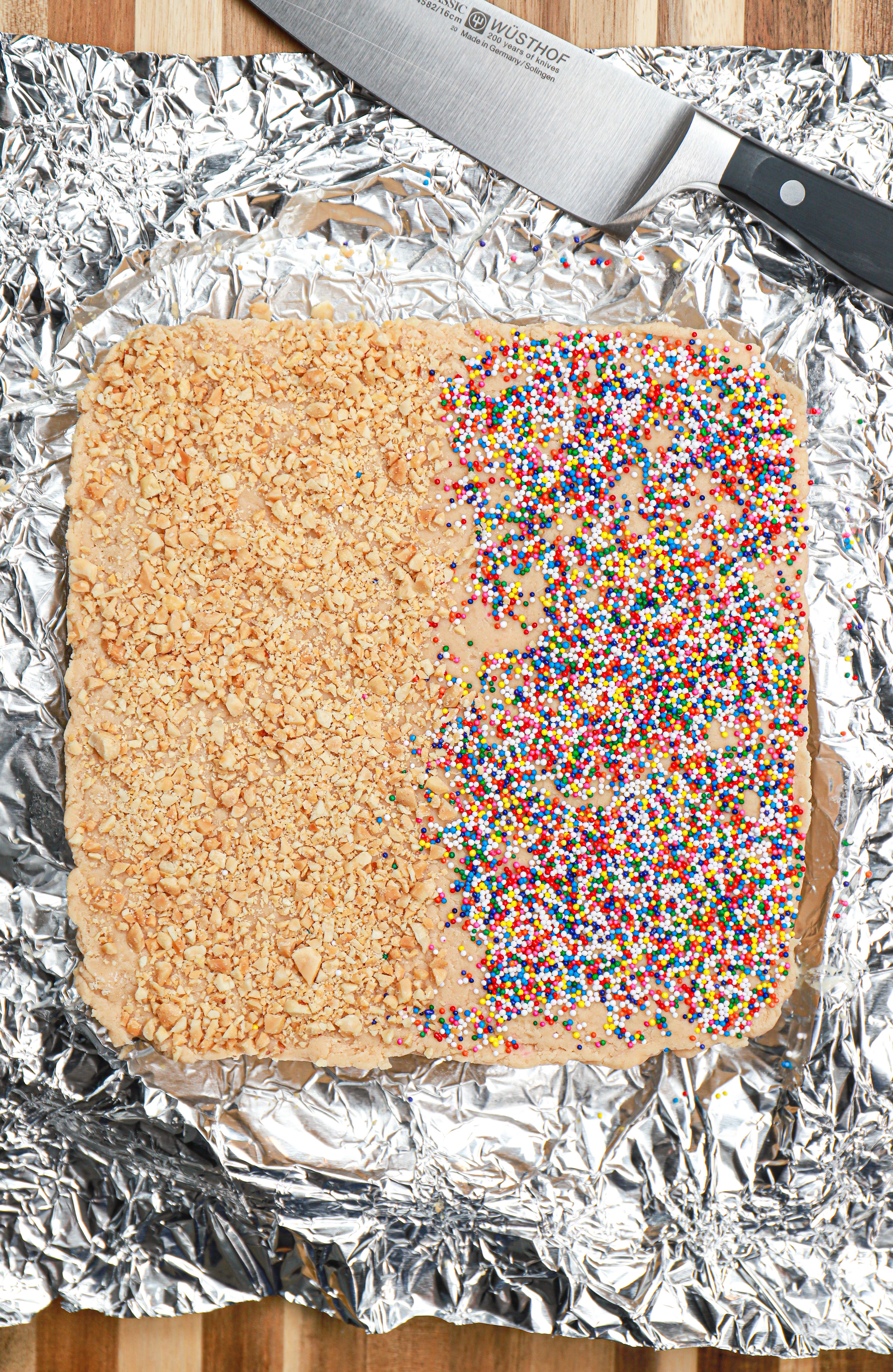 Creamy peanut butter fudge on a piece of aluminum foil before being cut into pieces.