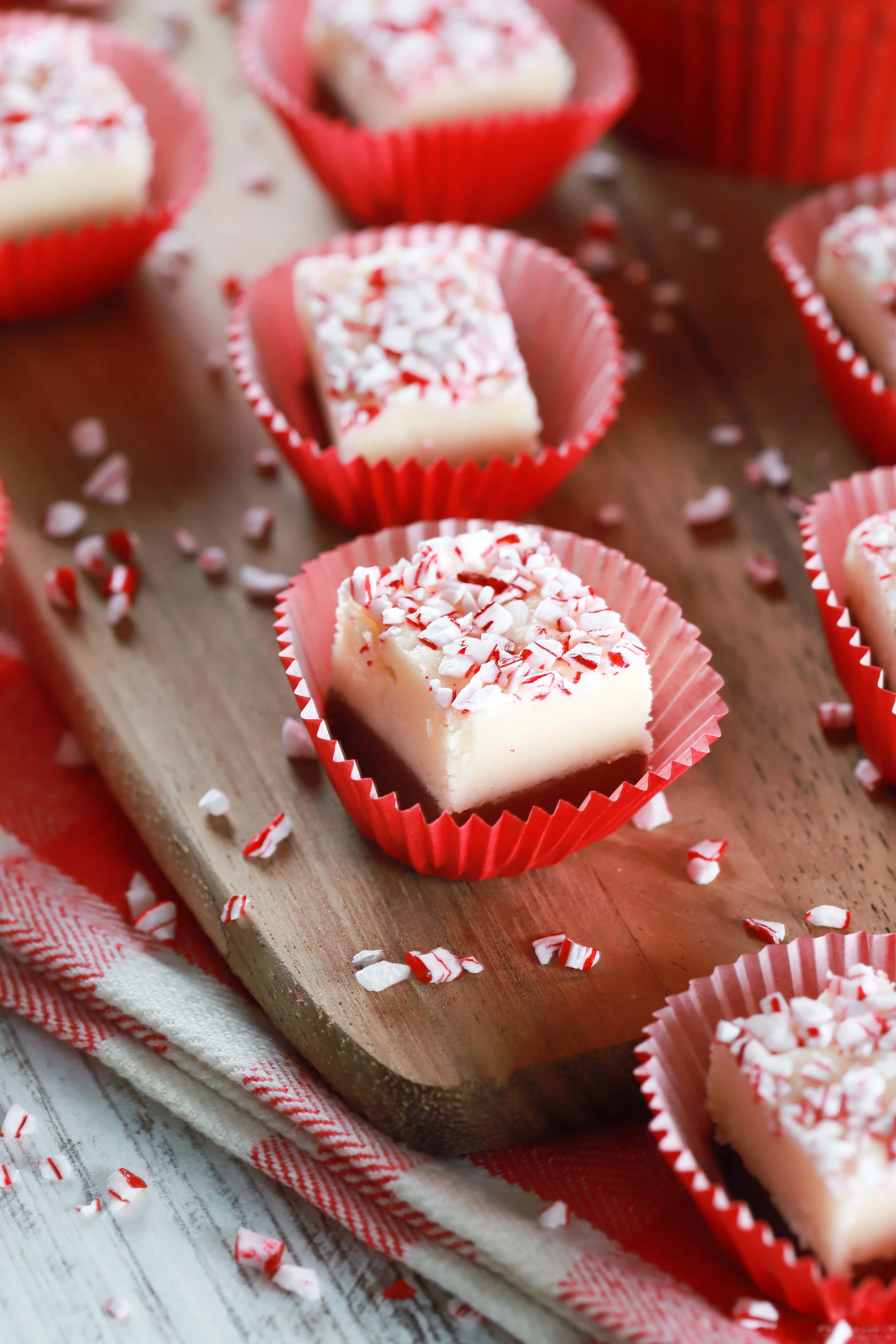 Overhead view of chocolate peppermint layered fudge in red cupcake liners. Recipe from A Kitchen Addiction