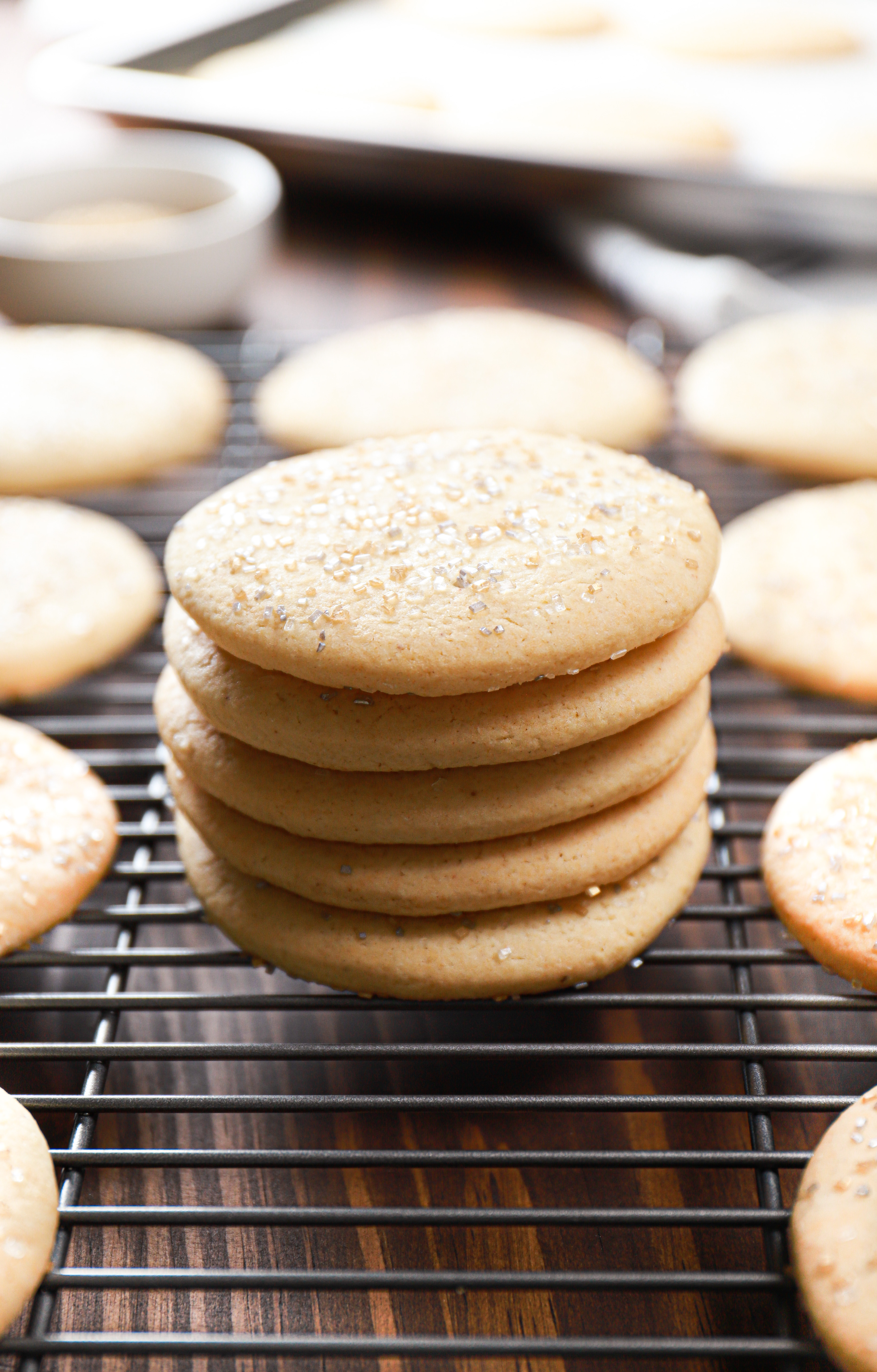 Stack of soft sour cream cookies on a wire baking rack.