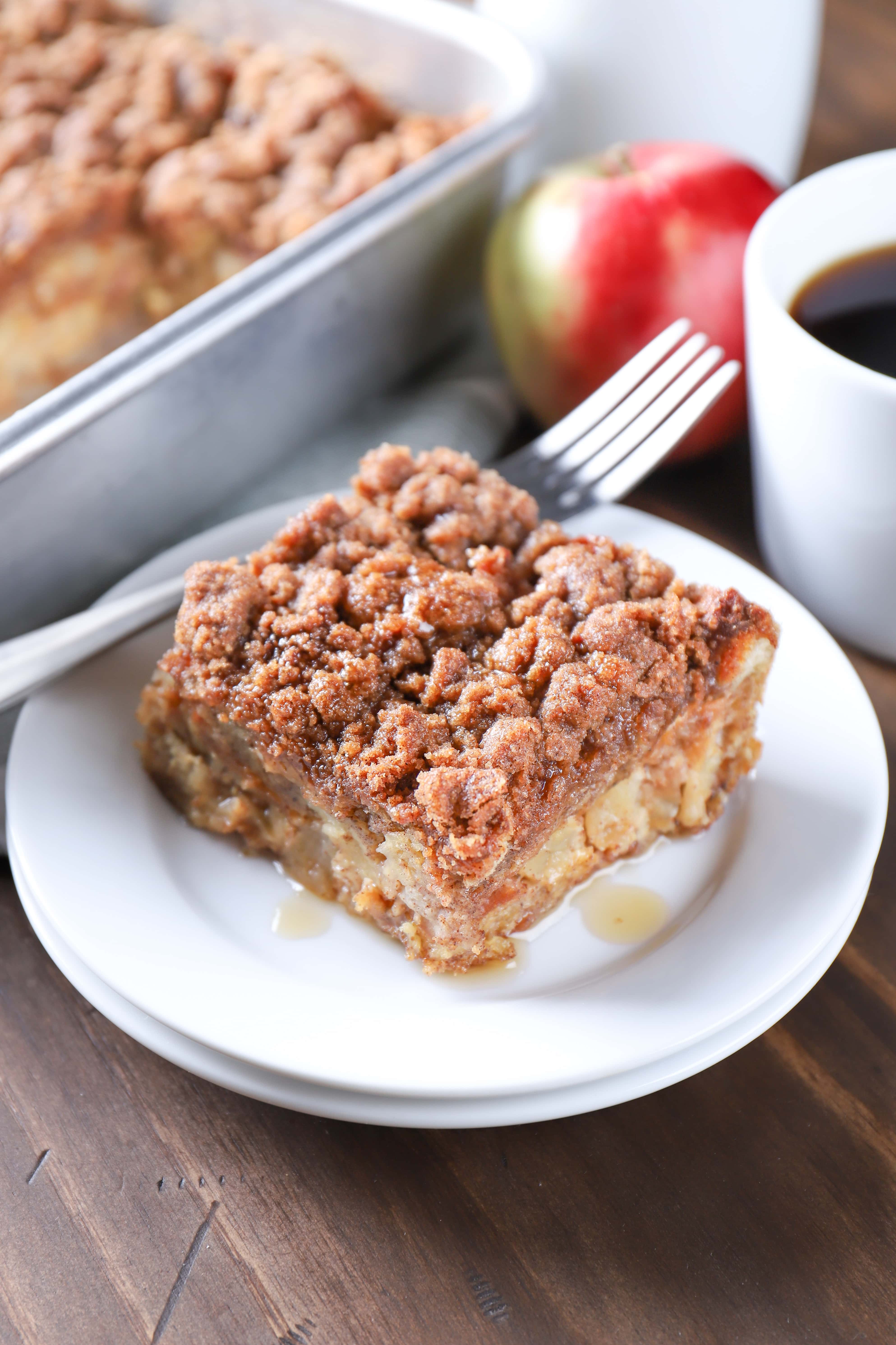 Piece of Apple Streusel French Toast Casserole with maple syrup. Recipe from A Kitchen Addiction