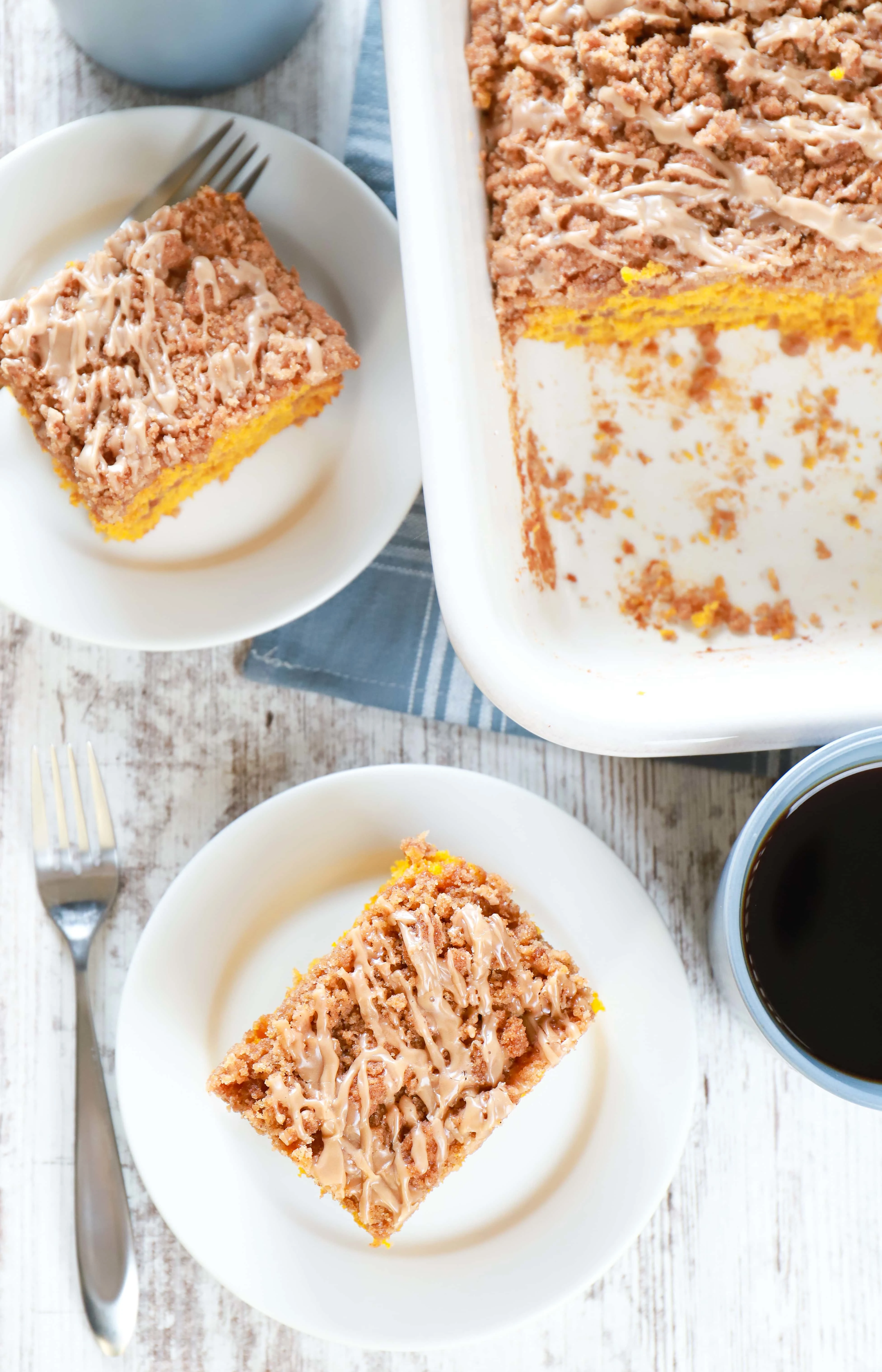 Pieces of maple cinnamon pumpkin coffee on white plates with cups of coffee. Recipe from A Kitchen Addiction