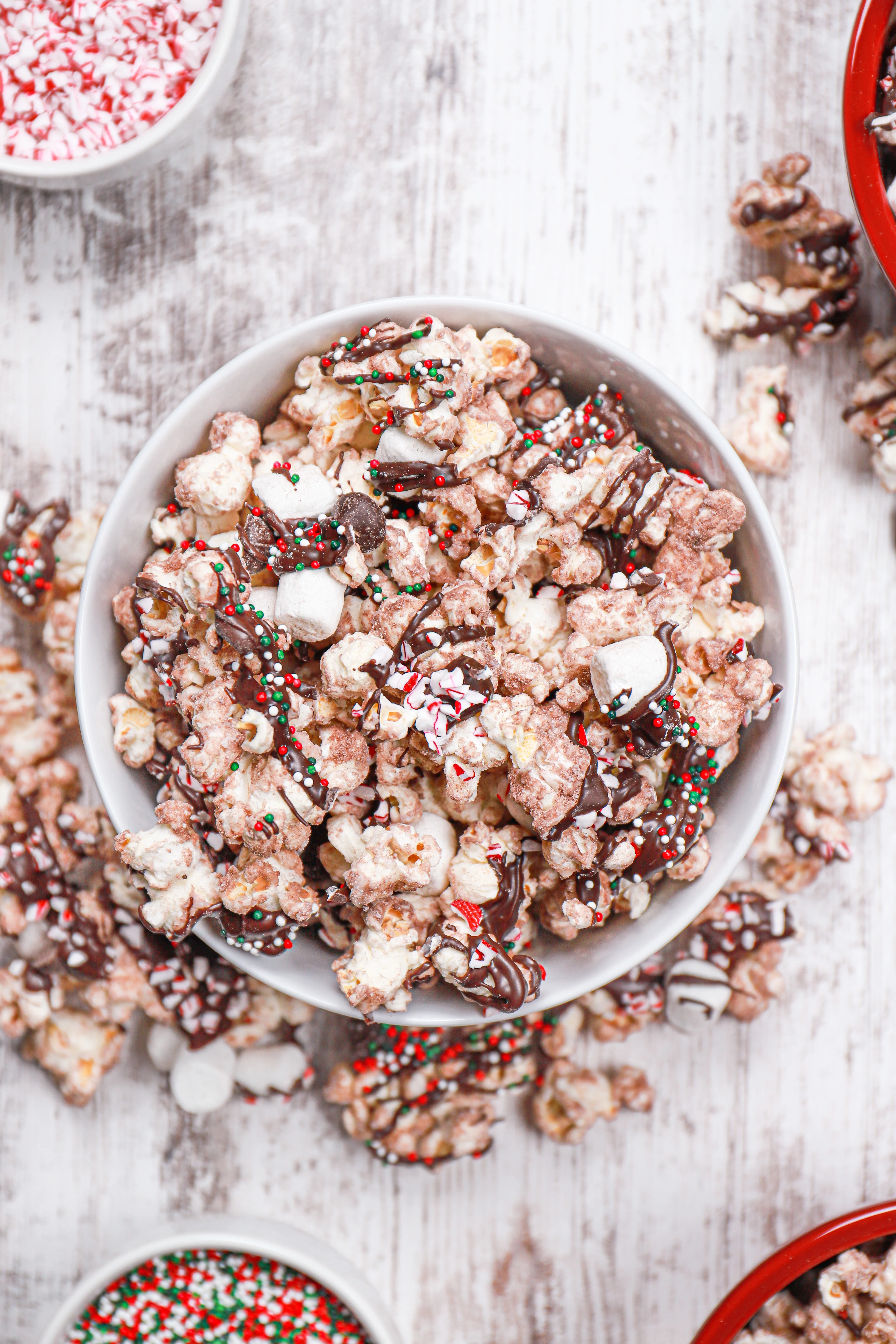 Overhead view of a batch of hot chocolate popcorn in a white bowl.