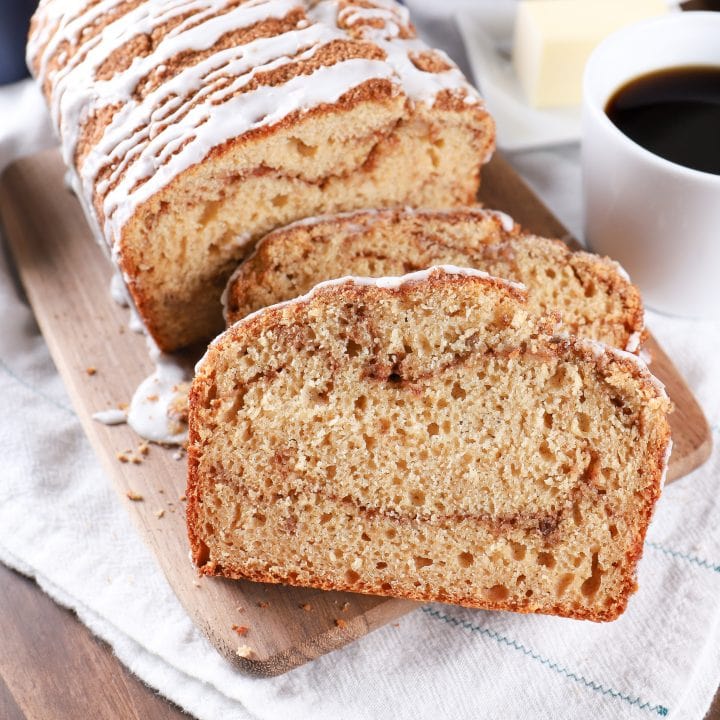 Sliced Cinnamon Swirl Yogurt Quick Bread on a cutting board