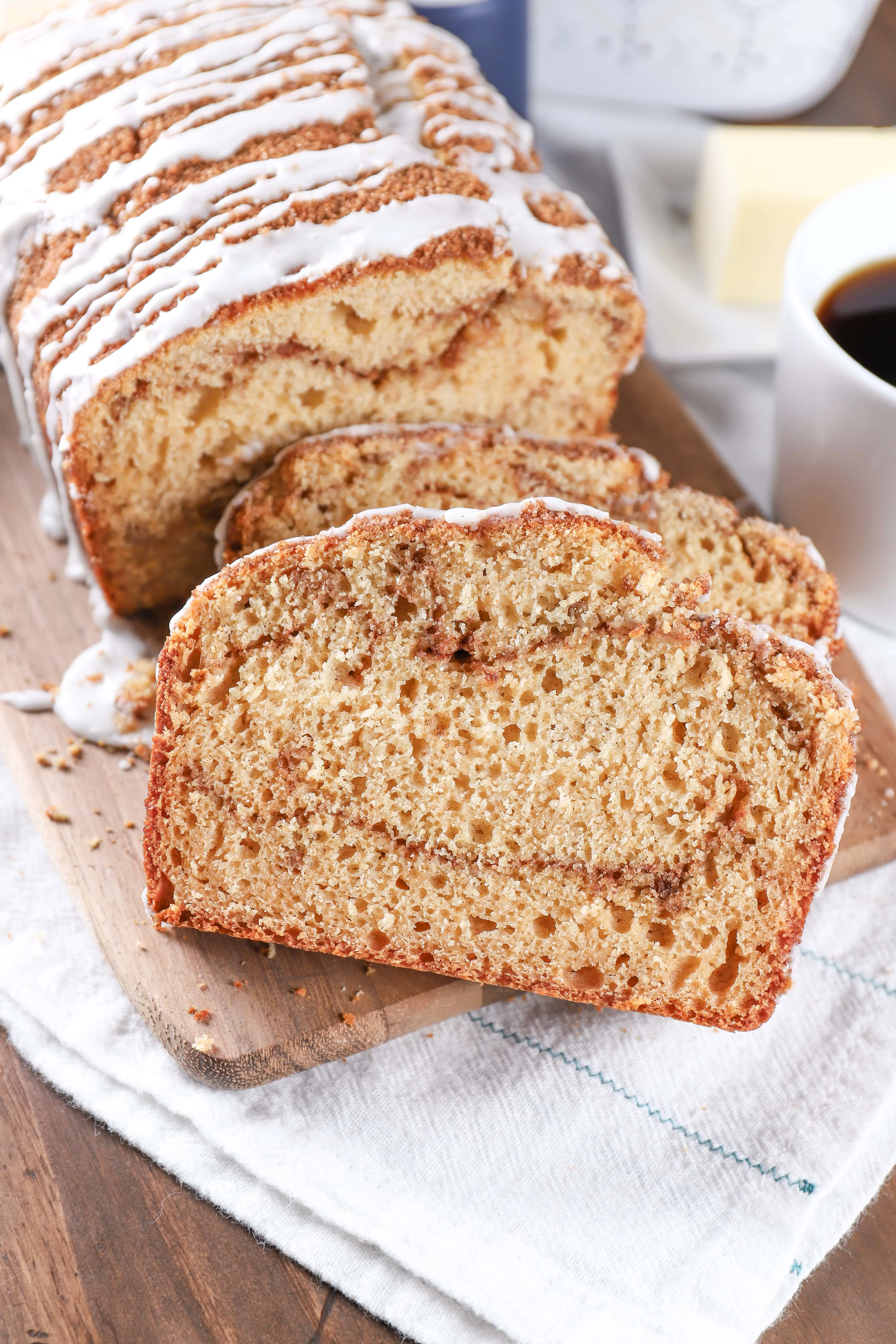 Two slices of cinnamon swirl yogurt quick bread on a cutting board. Recipe for the bread from A Kitchen Addiction.