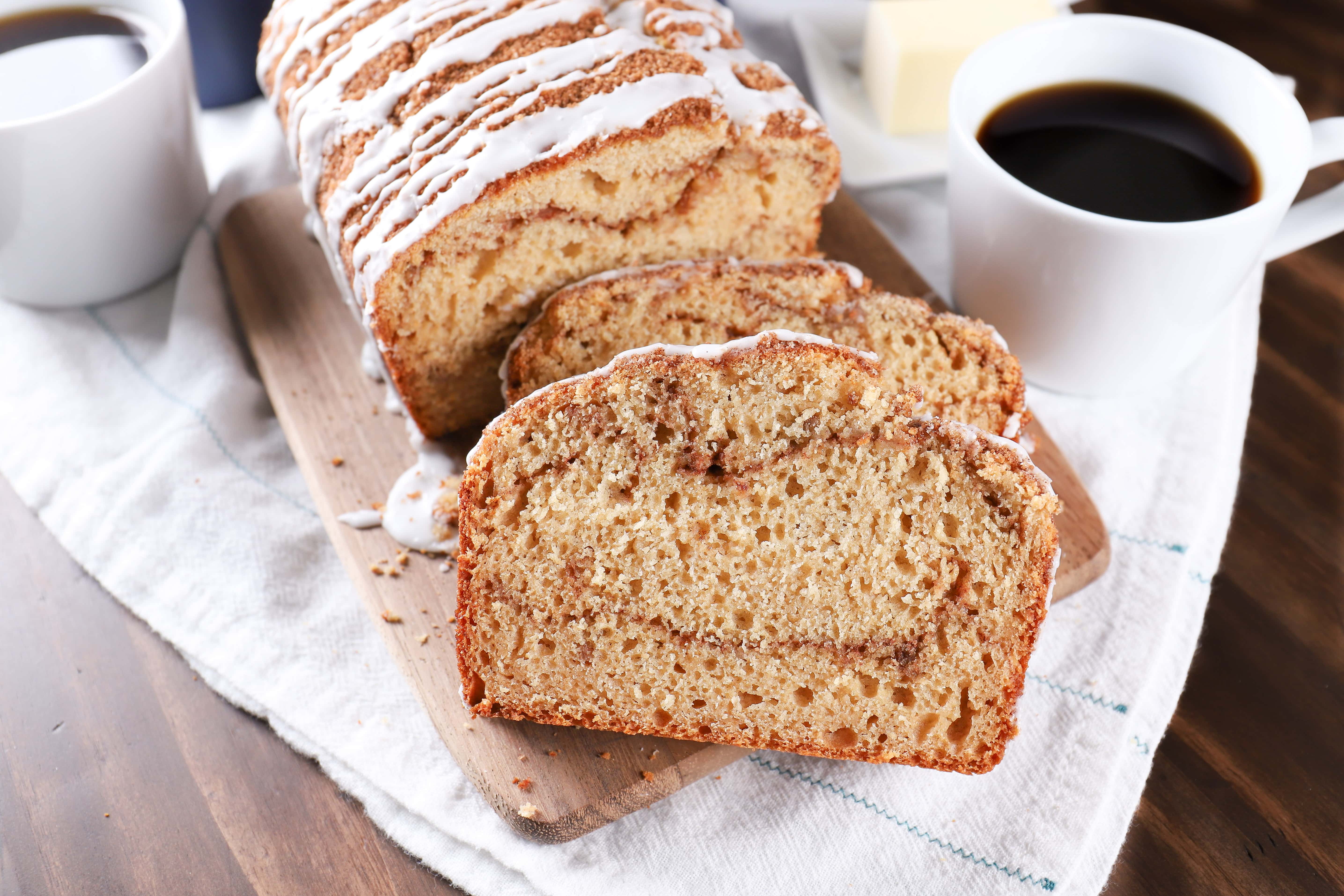 Sliced Cinnamon Swirl Yogurt Quick Bread on a cutting board