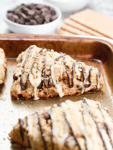 Up close side view of a s'mores scone on a baking sheet.