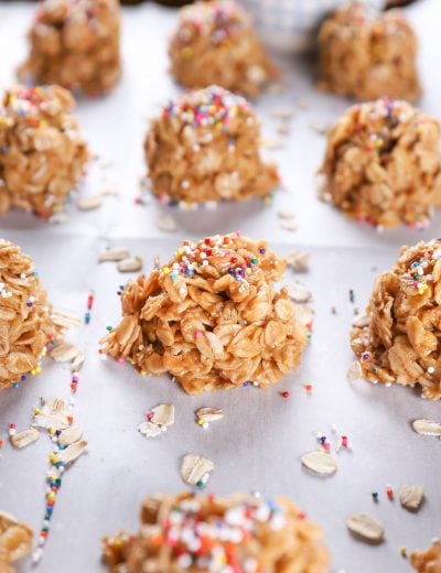 Up close image of a peanut butter honey no bake cookie on a baking sheet full of no bake cookies.