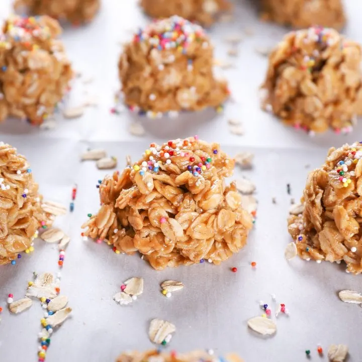 Up close image of a peanut butter honey no bake cookie on a baking sheet full of no bake cookies.