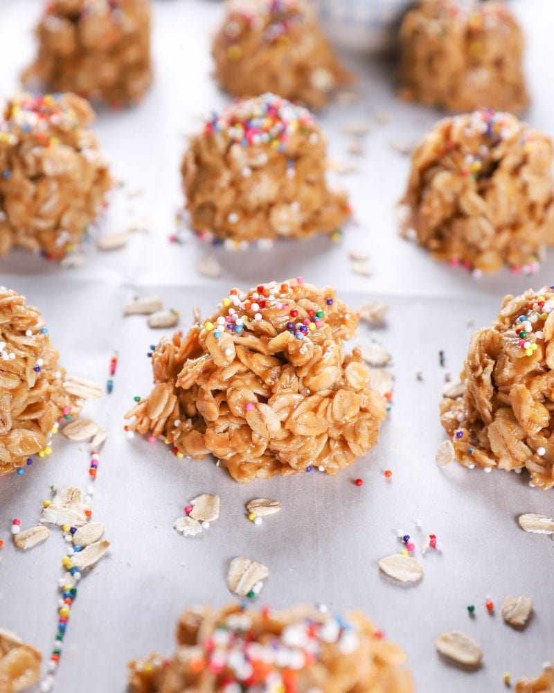 Up close image of a peanut butter honey no bake cookie on a baking sheet full of no bake cookies.