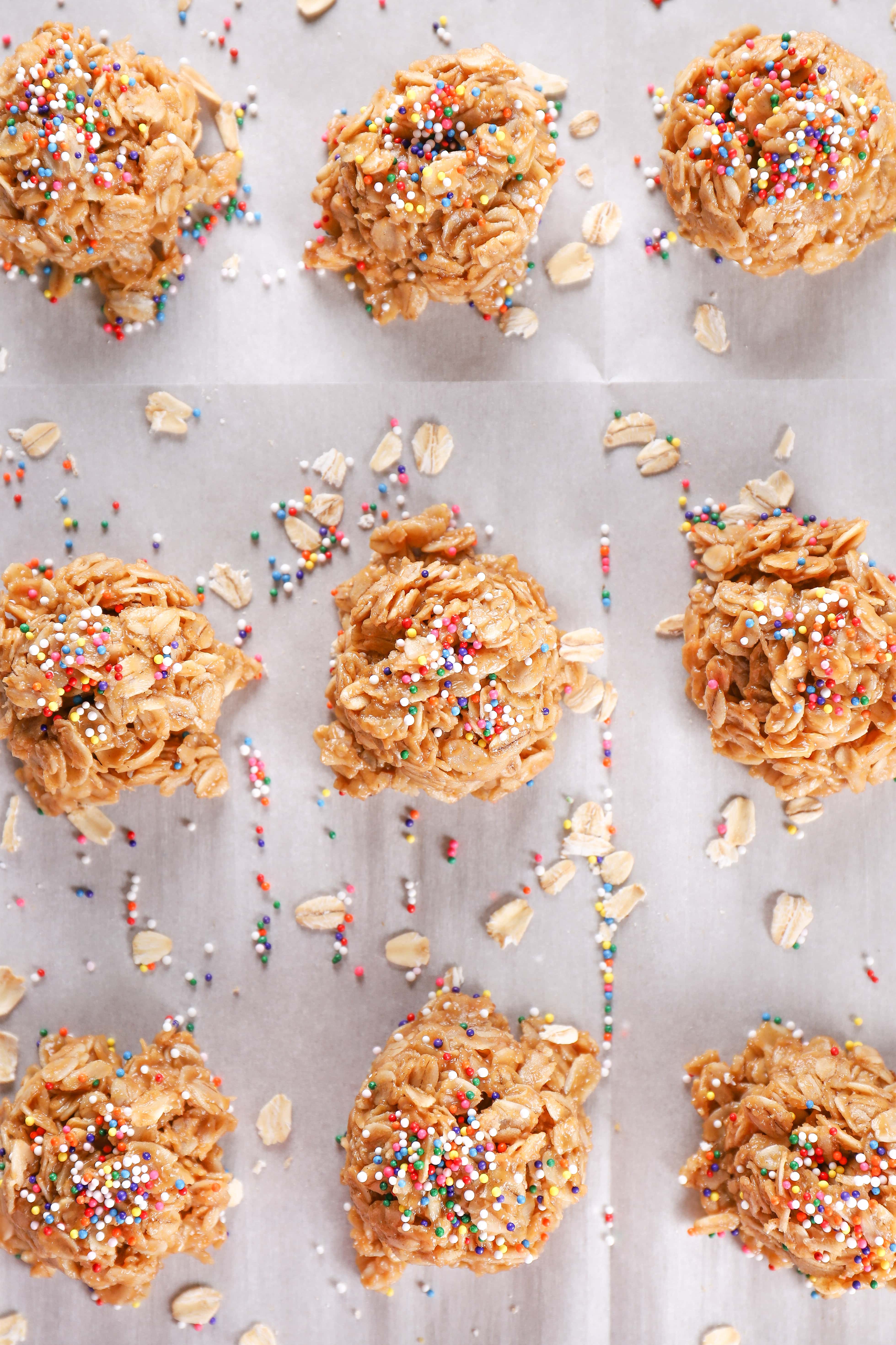 Overhead shot of lighter peanut butter honey no bake cookies topped with sprinkles on a baking sheet. Recipe from A Kitchen Addiction