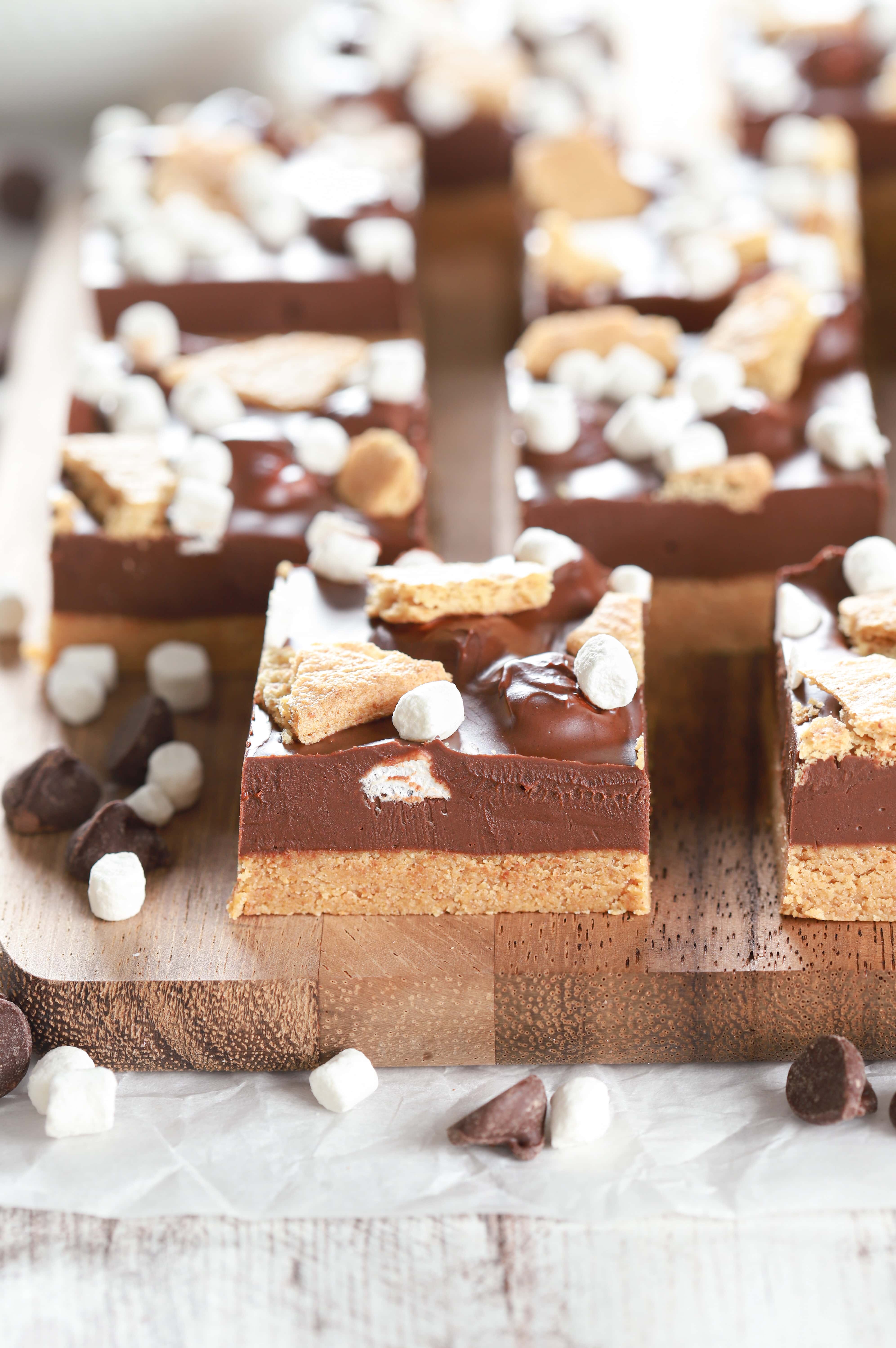 Up close side view of a no bake peanut butter smores bar with more bars in the background.