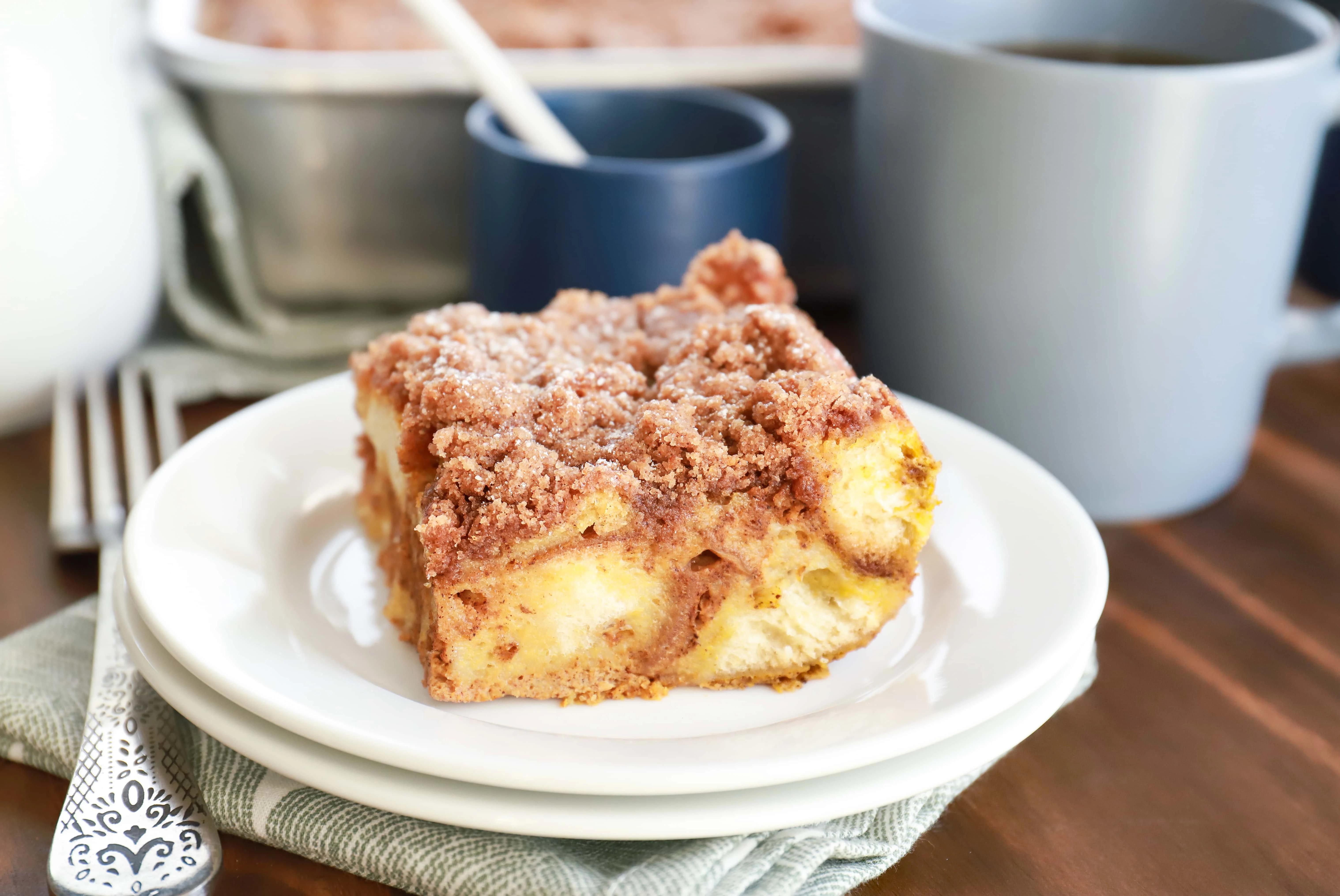 Up close image of a piece of Pumpkin French Toast Casserole on a white plate. Recipe from A Kitchen Addiction