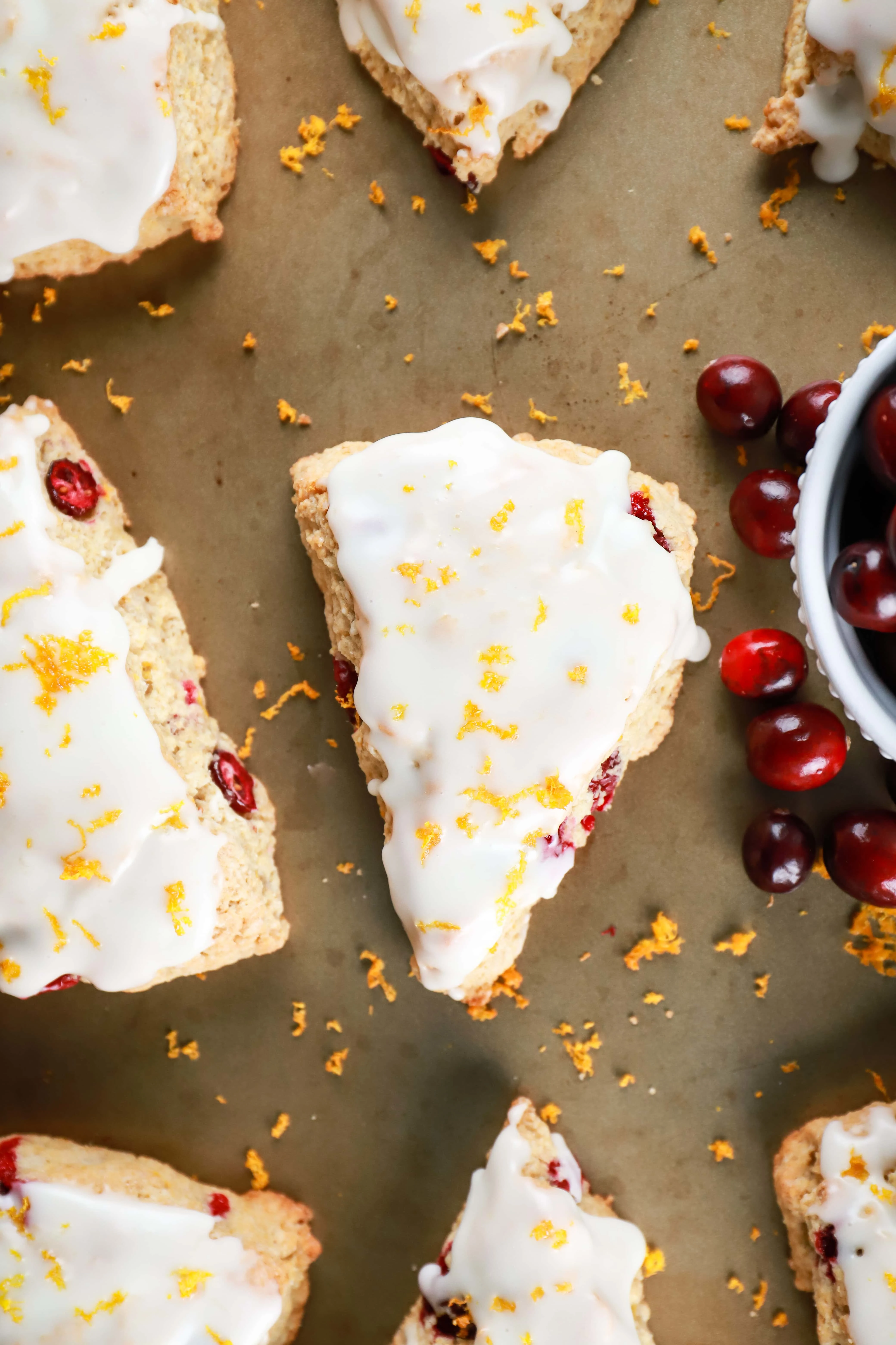 Overhead view of Cranberry Orange Scones on a baking sheet. Recipe from A Kitchen Addiction