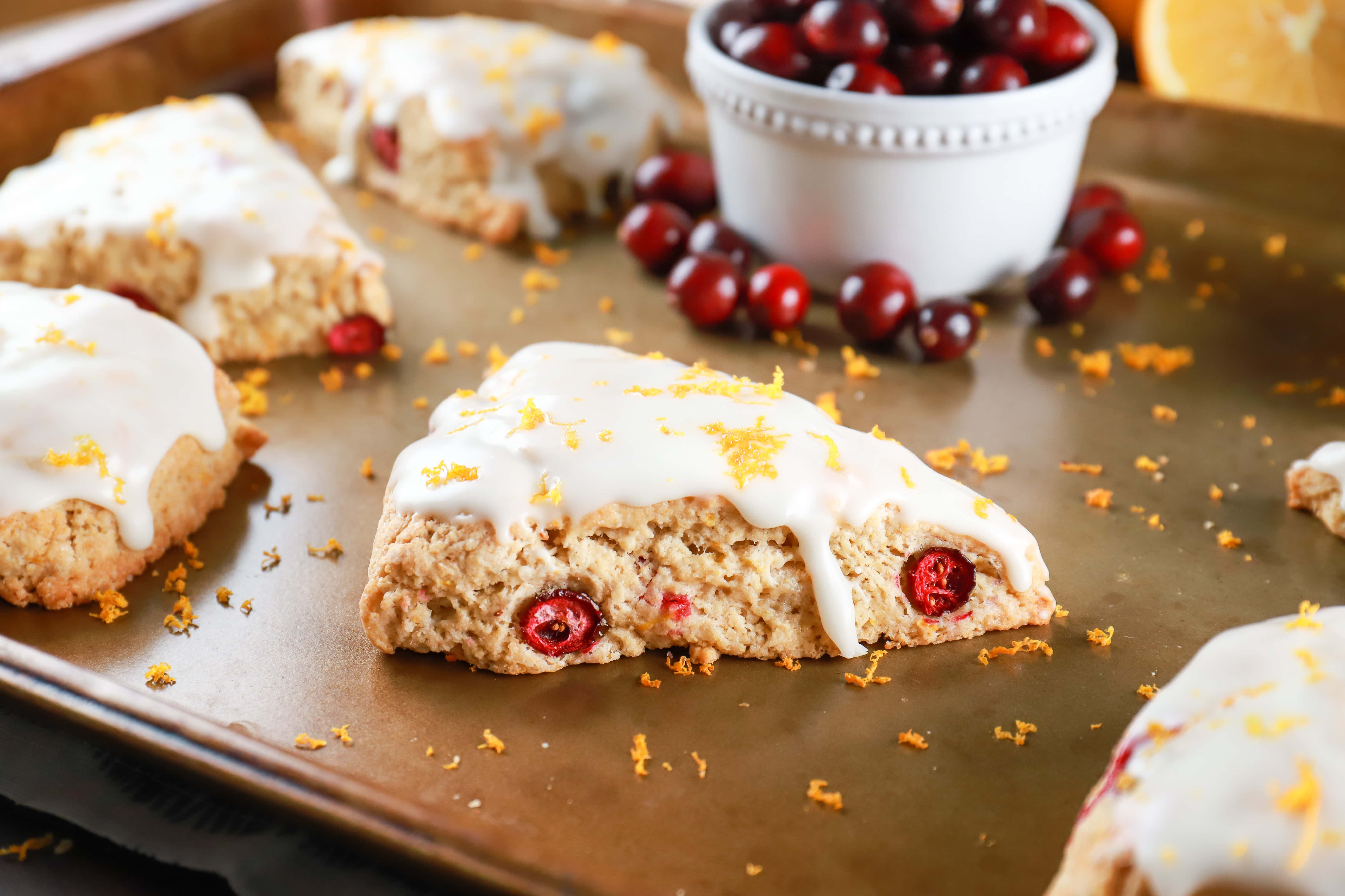 Up close view of a cranberry orange scone on a cookie sheet. Recipe from A Kitchen Addiction