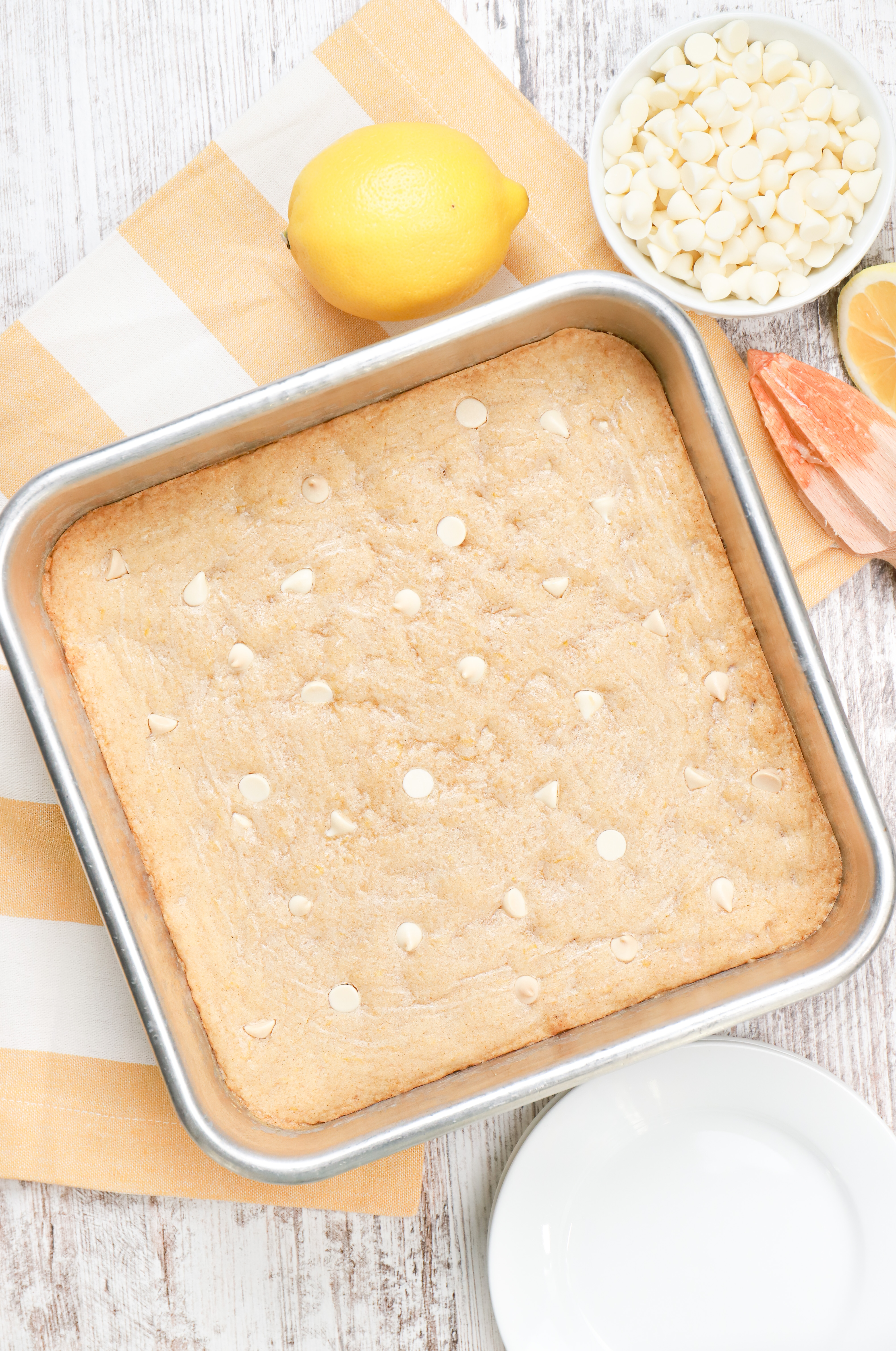 Overhead view of a batch of white chocolate lemon blondies in an aluminum baking dish.