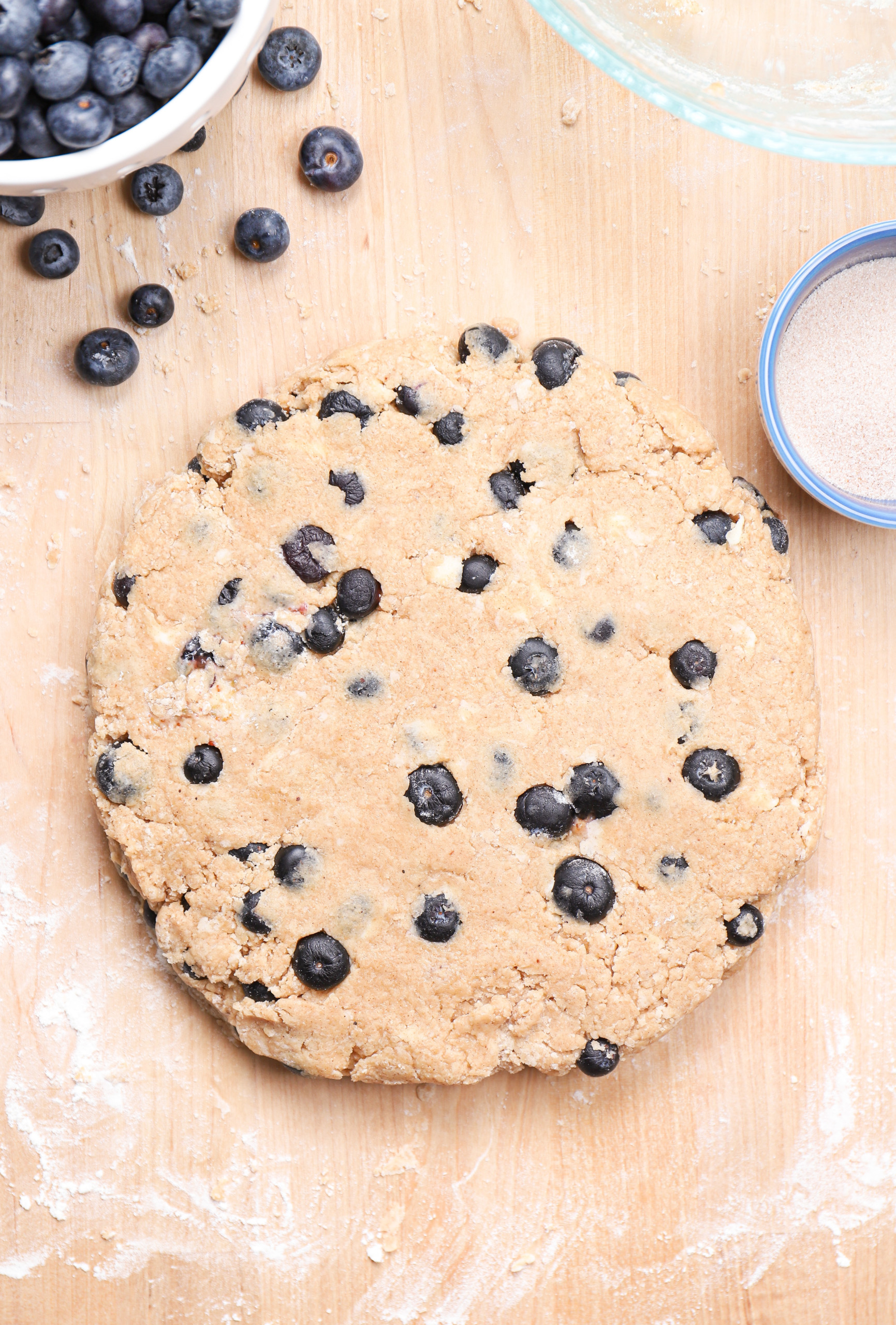 Blueberry snickerdoodle scone dough shaped into an eight inch circle.