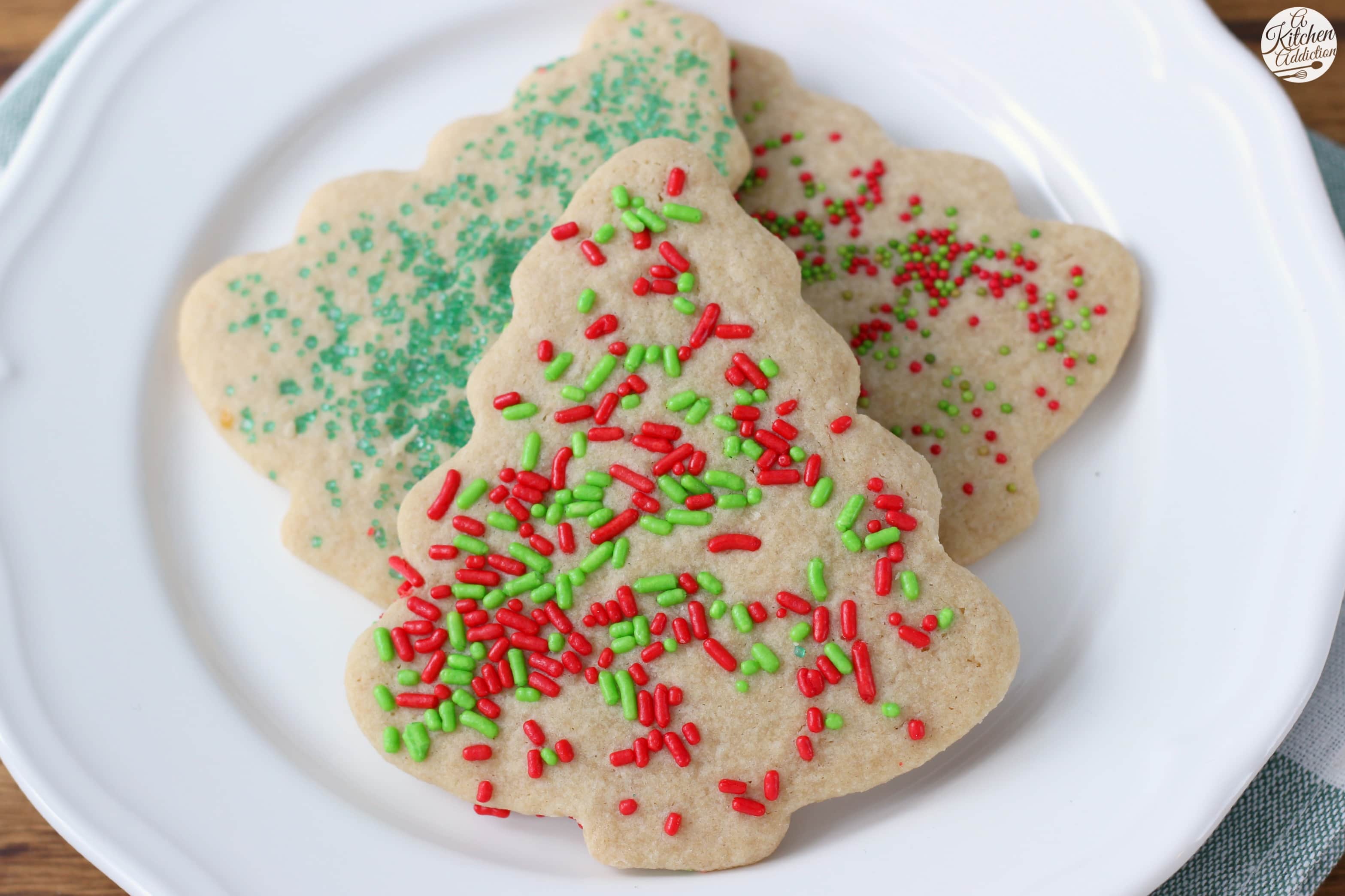 https://www.a-kitchen-addiction.com/wp-content/uploads/2015/12/lightened-up-sugar-cookies-w-name1.jpg