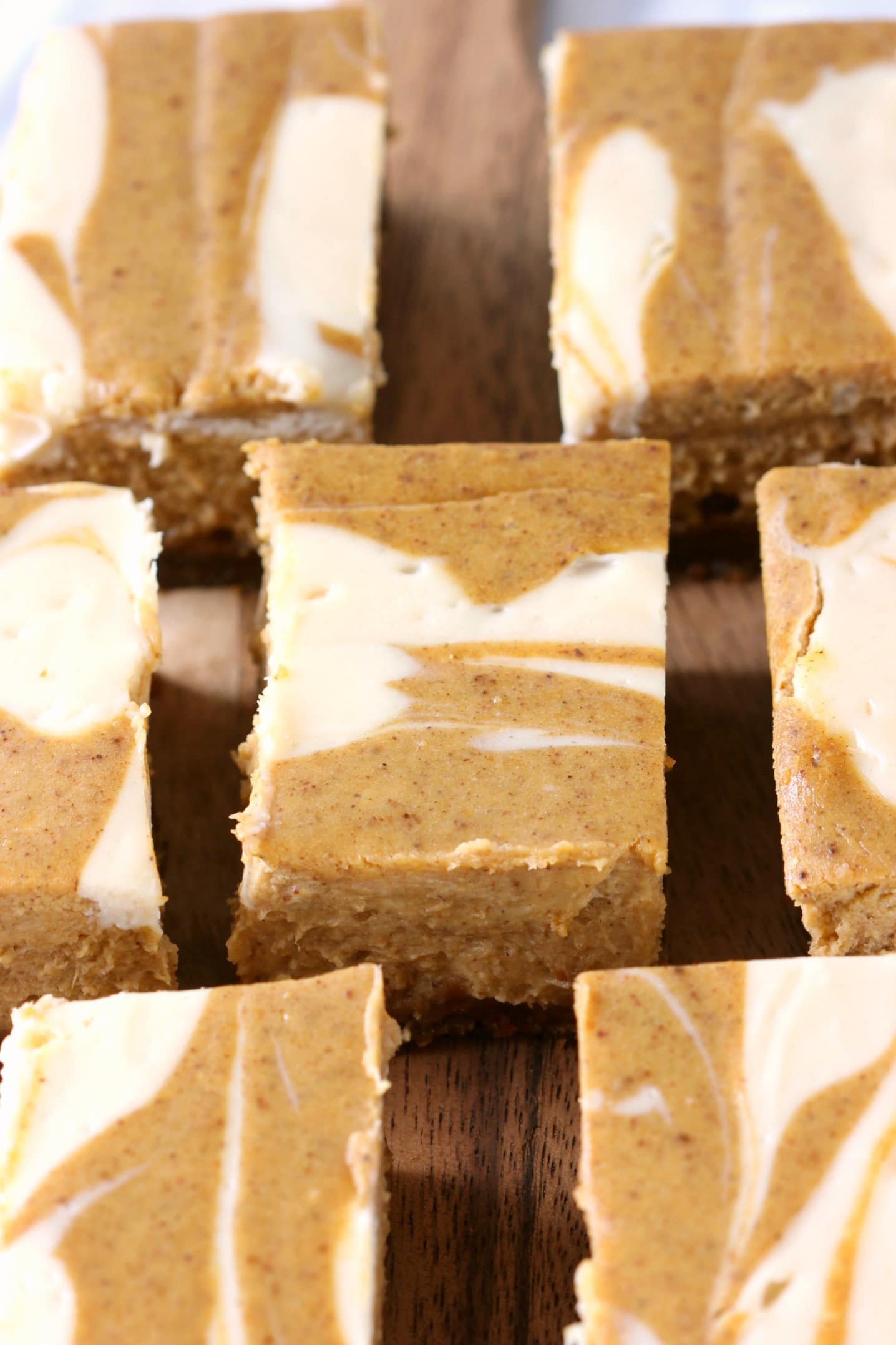 Creamy Swirled Pumpkin Cheesecake Bars with Gingersnap Crust Recipe from A Kitchen Addiction
