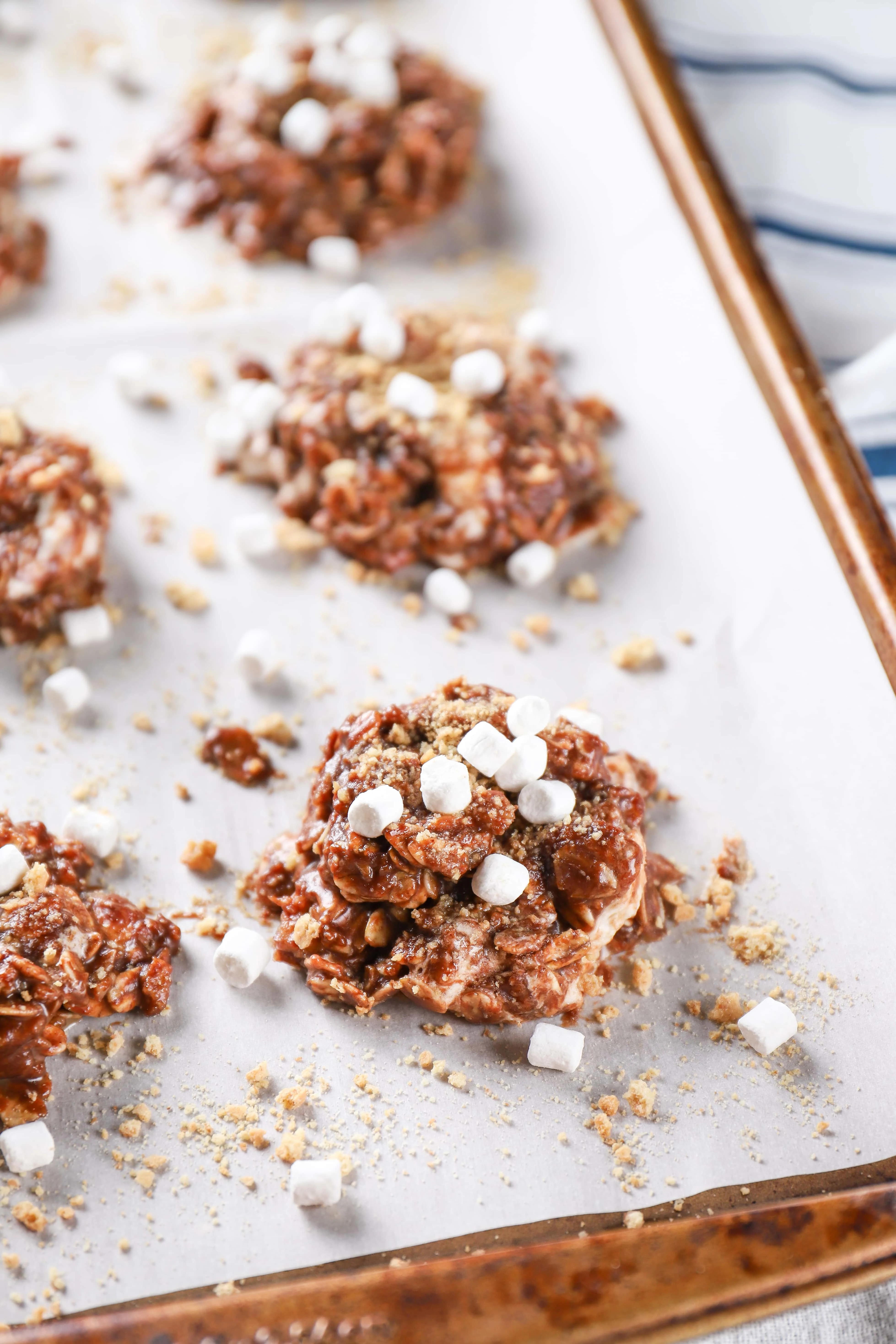 Easy Smores No Bake Cookies on a parchment paper lined baking sheet. Recipe from A Kitchen Addiction