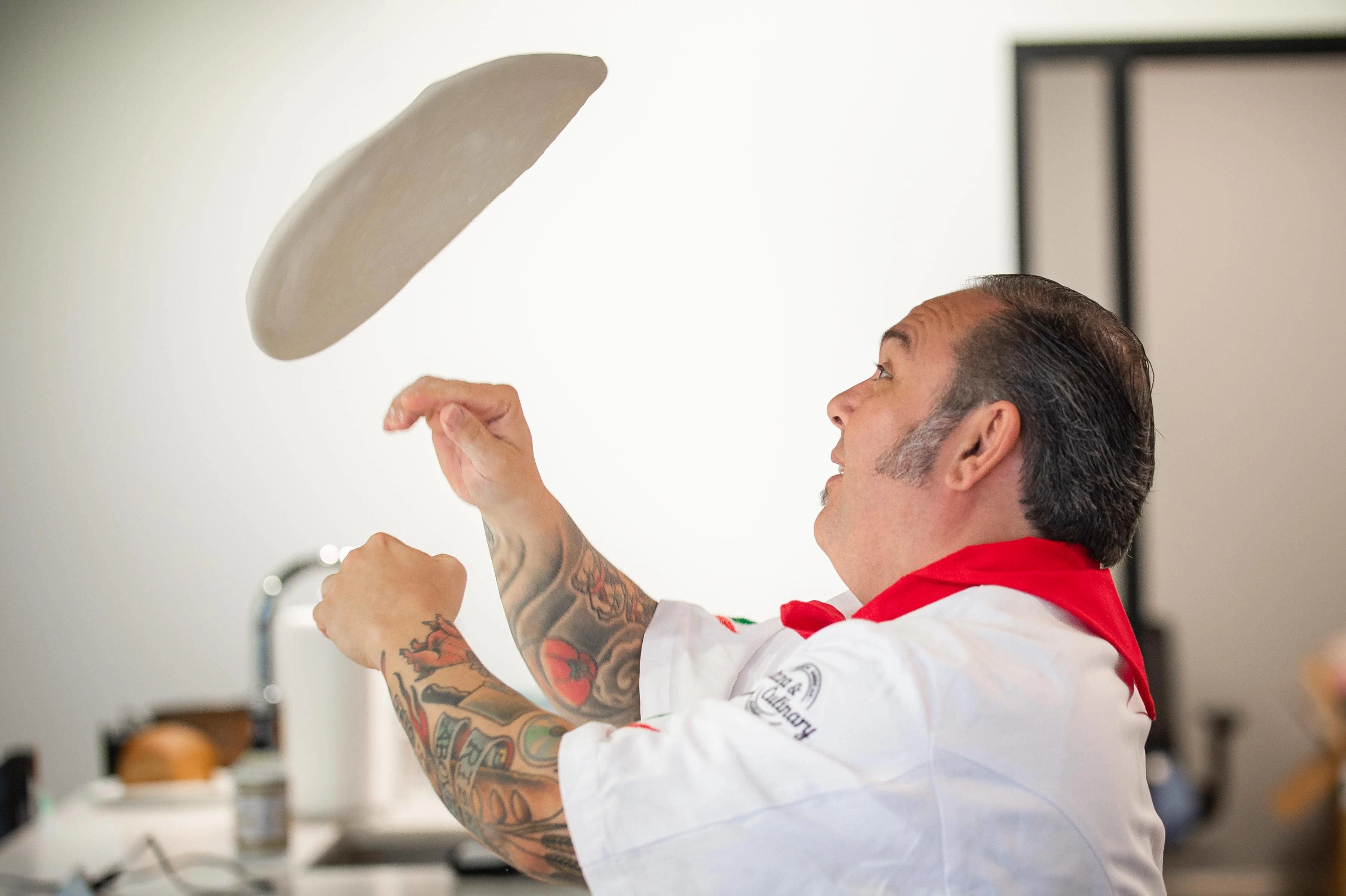 Chef Leo tossing pizza crust