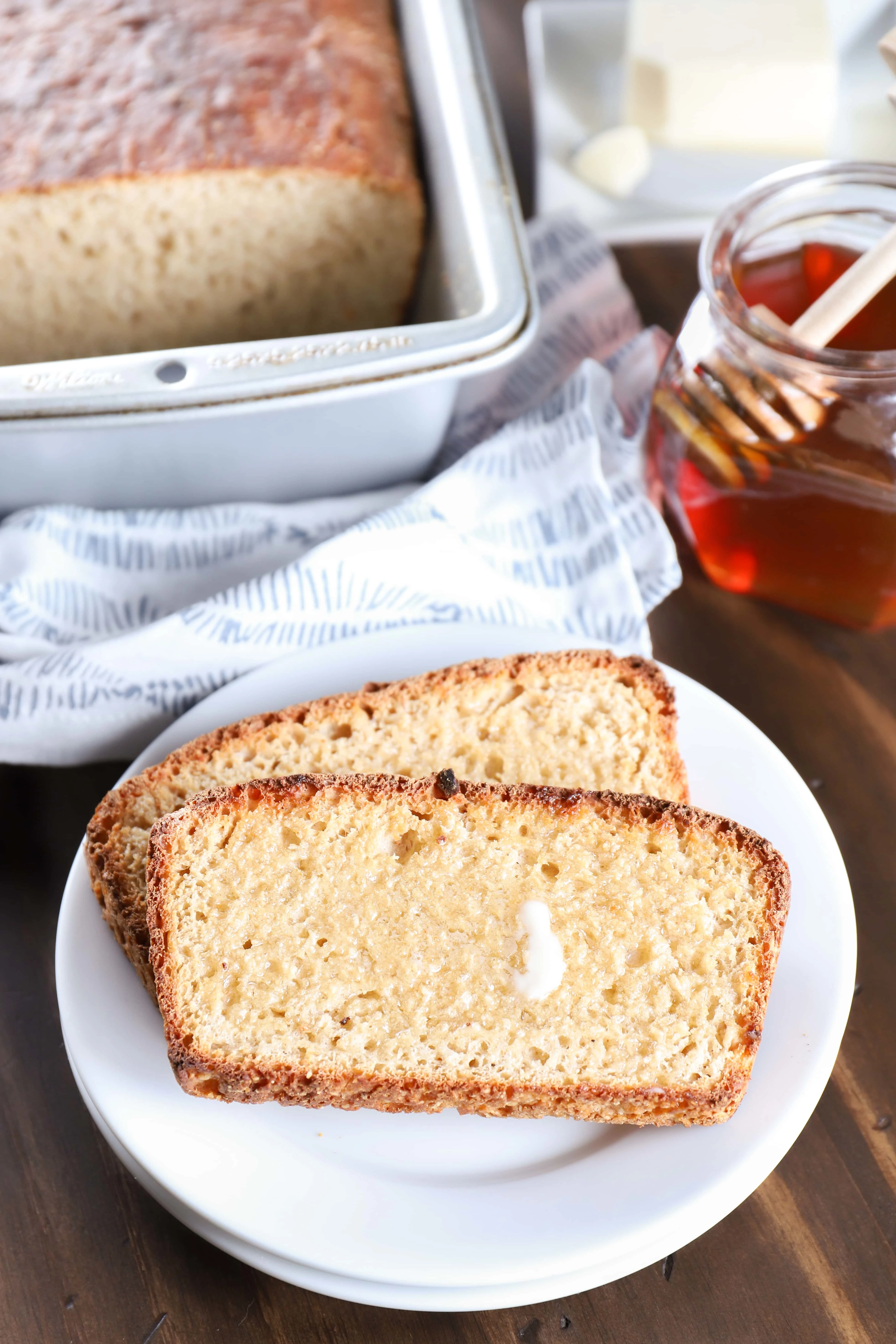 Two Pieces of Sourdough English Muffin Bread Toasted and Buttered. Recipe from A Kitchen Addiction