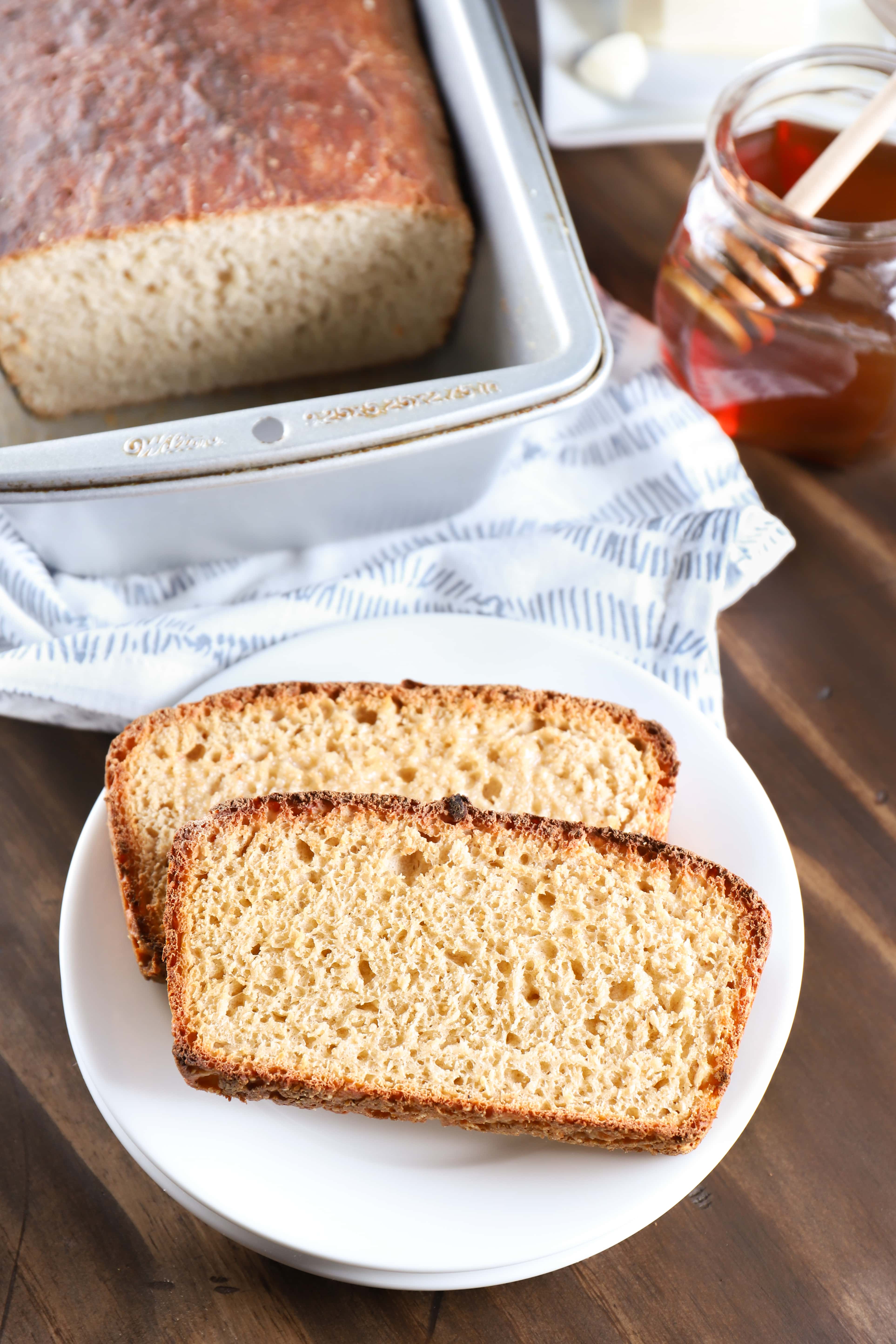 Toasted Sourdough English Muffin Bread on a plate. Recipe for bread from A Kitchen Addiction