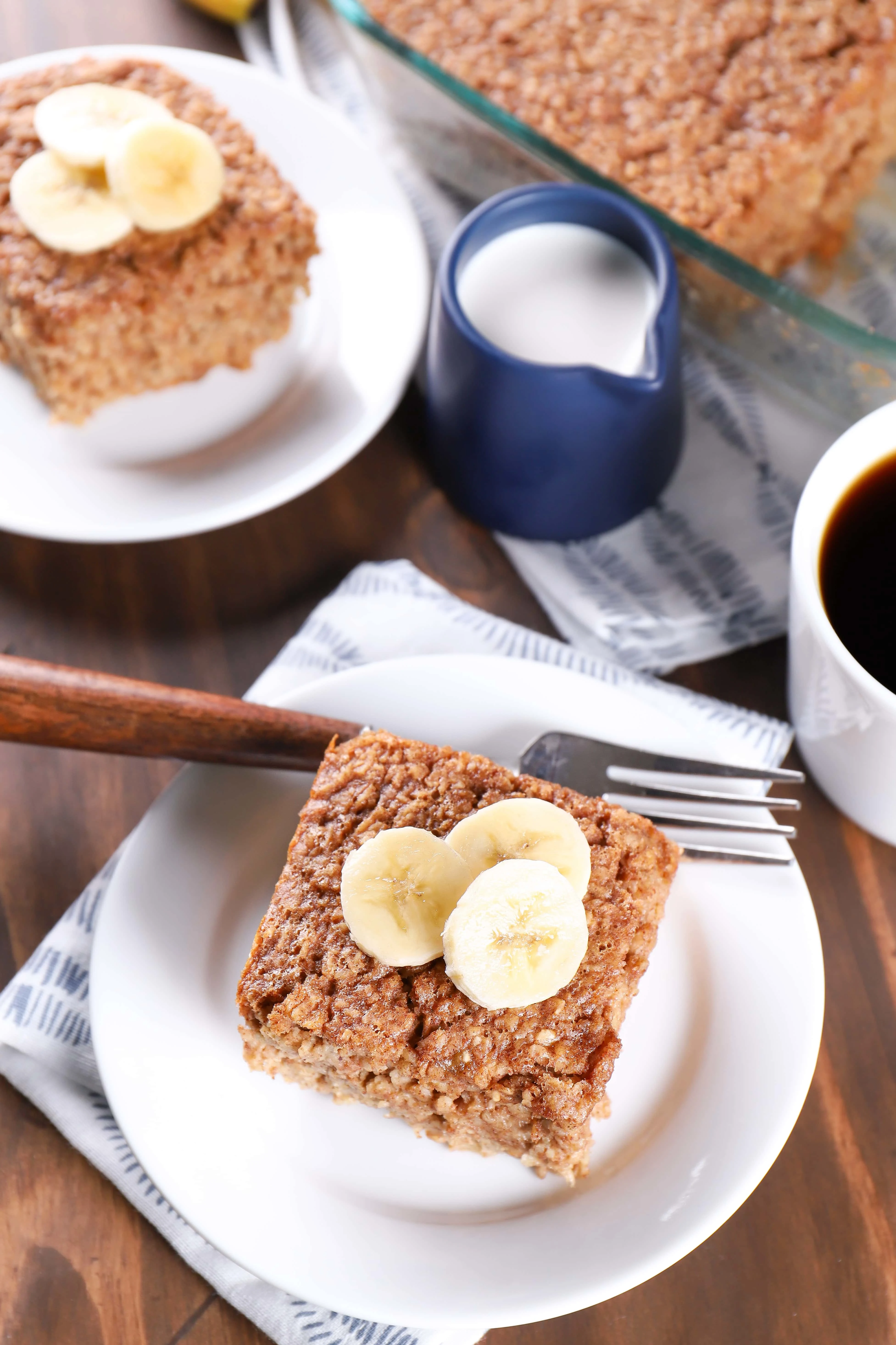 Plates with pieces of almond butter banana bread baked oatmeal. Recipe from A Kitchen Addiction
