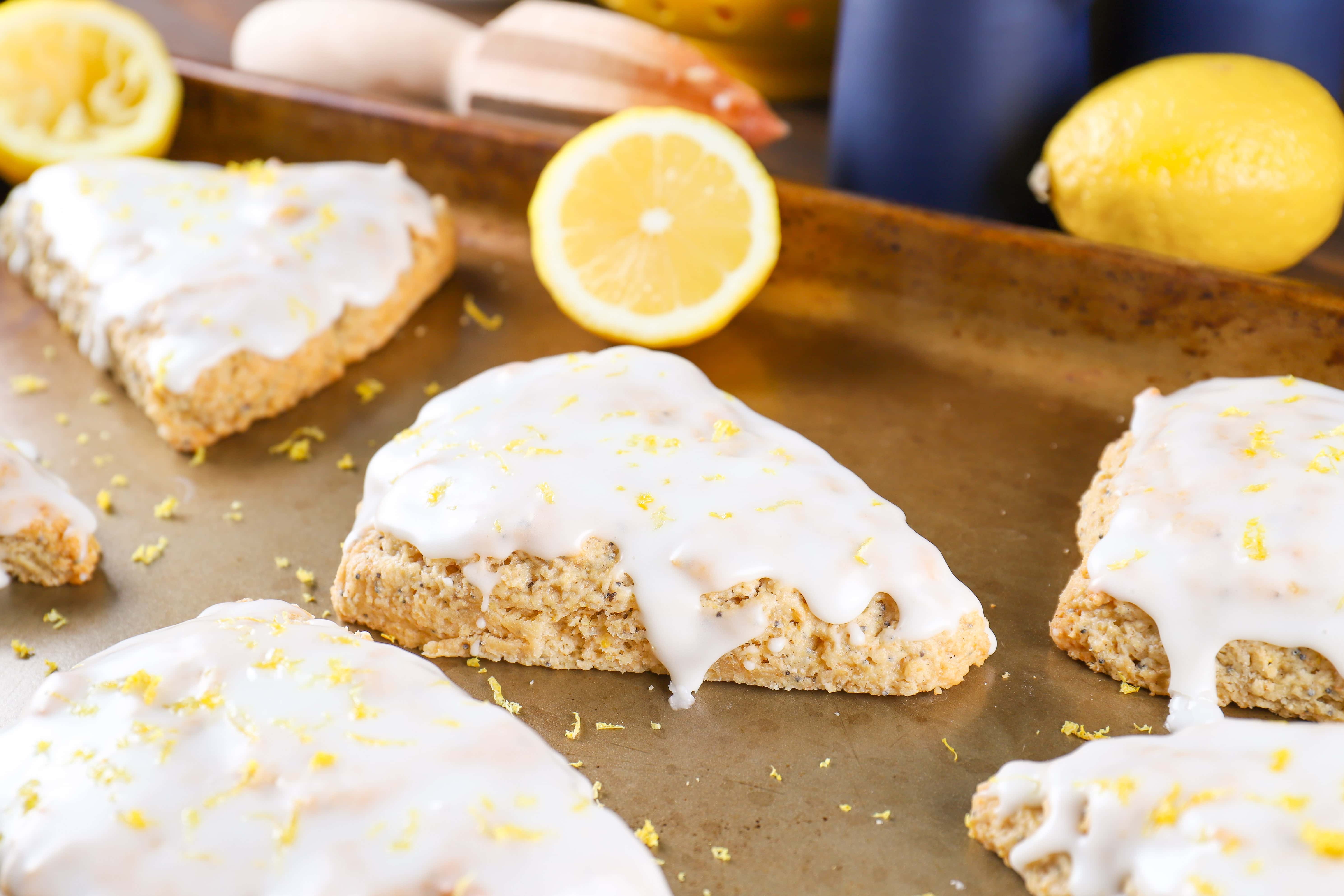 Lemon Poppy Seed Scone glazed and topped with fresh lemon zest. Recipe from A Kitchen Addiction
