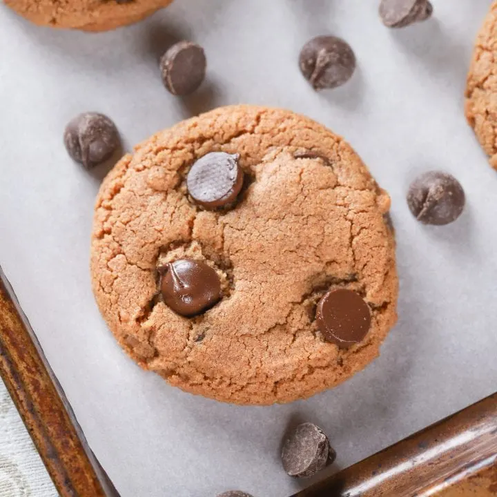 Up close image of a flourless almond butter chocolate chip cookie. Recipe from A Kitchen Addiction