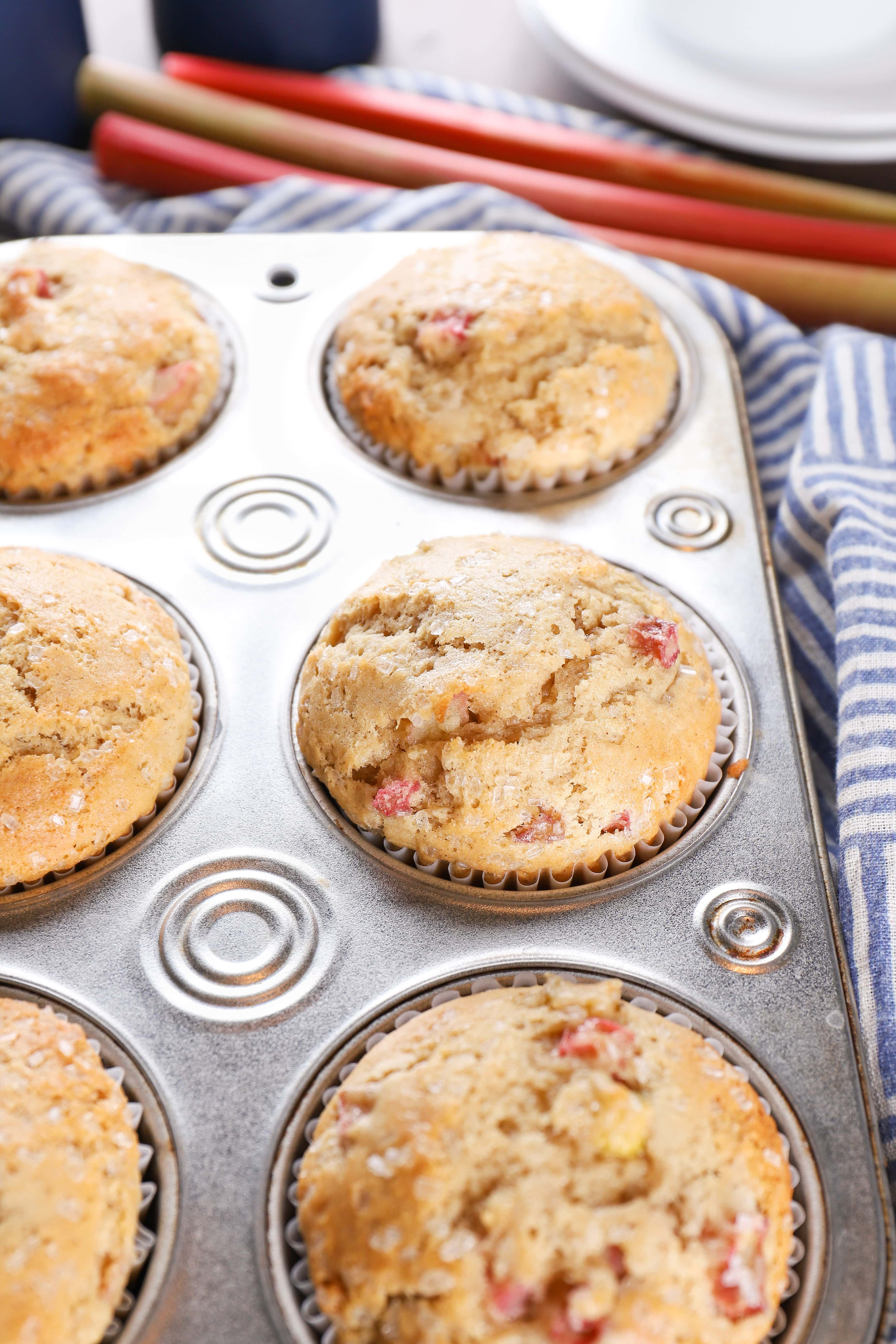 Muffin tin full of bakery style rhubarb muffins