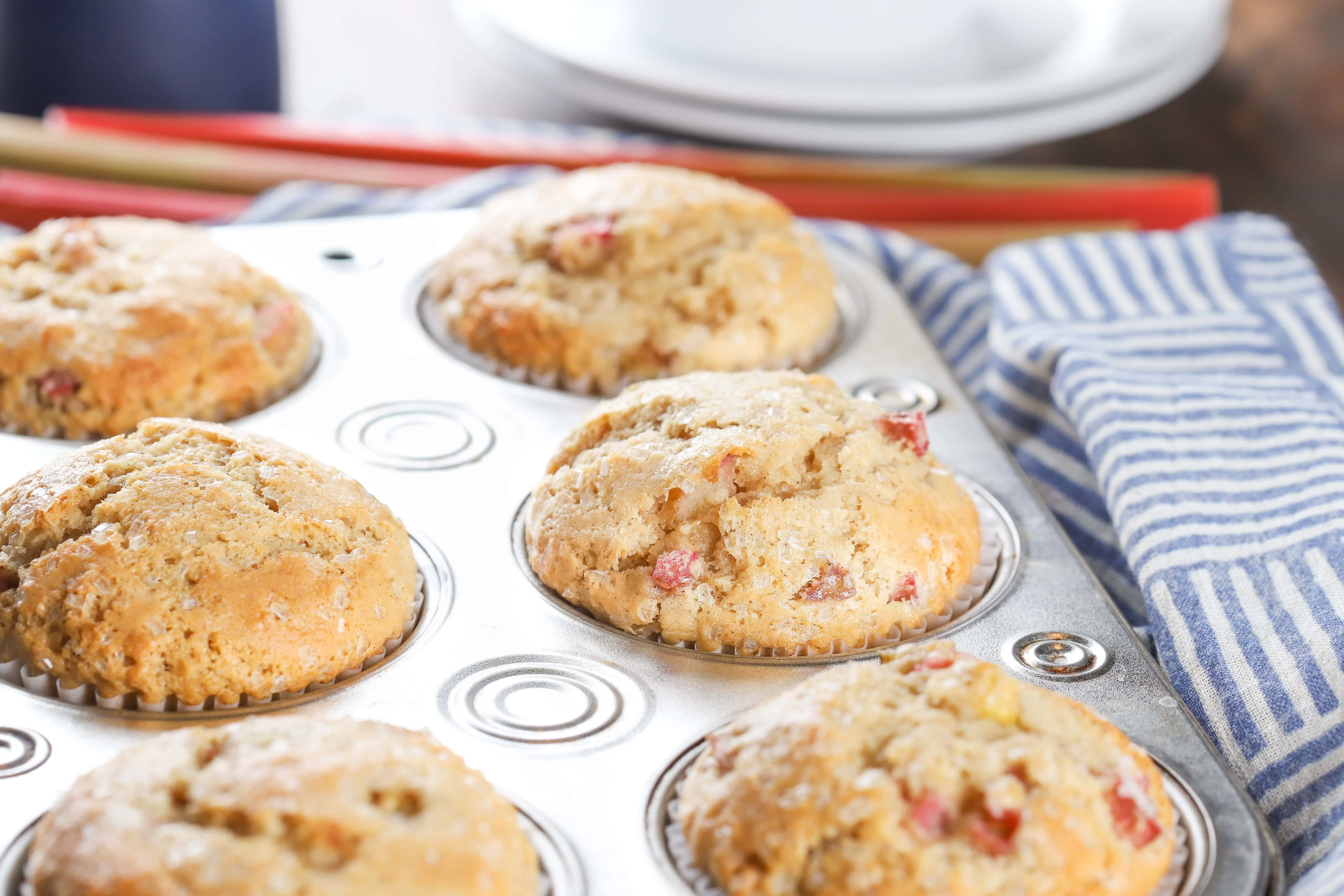 Up close image of a bakery style rhubarb muffin in a muffin tin
