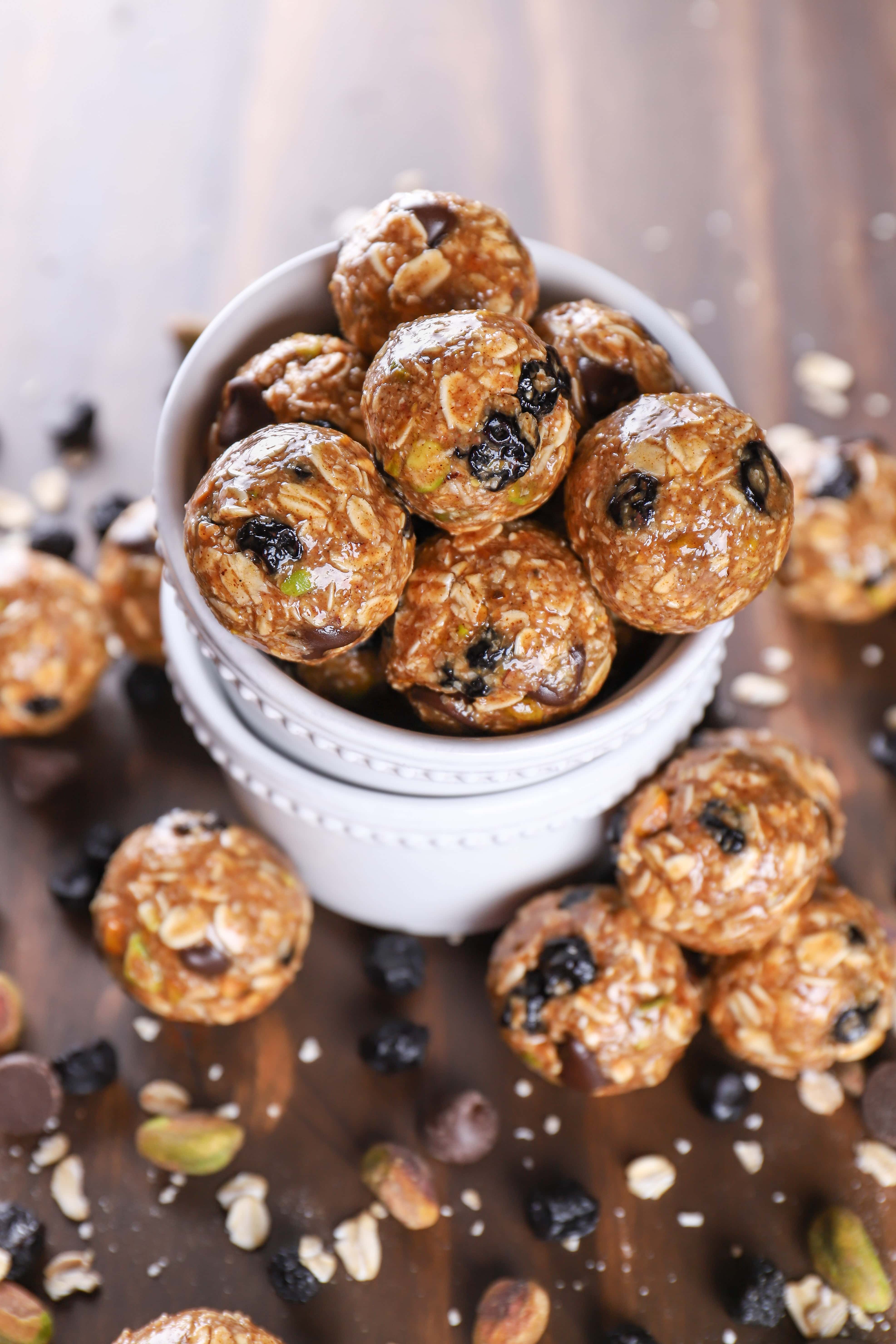 above image of a bowl of no bake dark chocolate blueberry pistachio granola bites