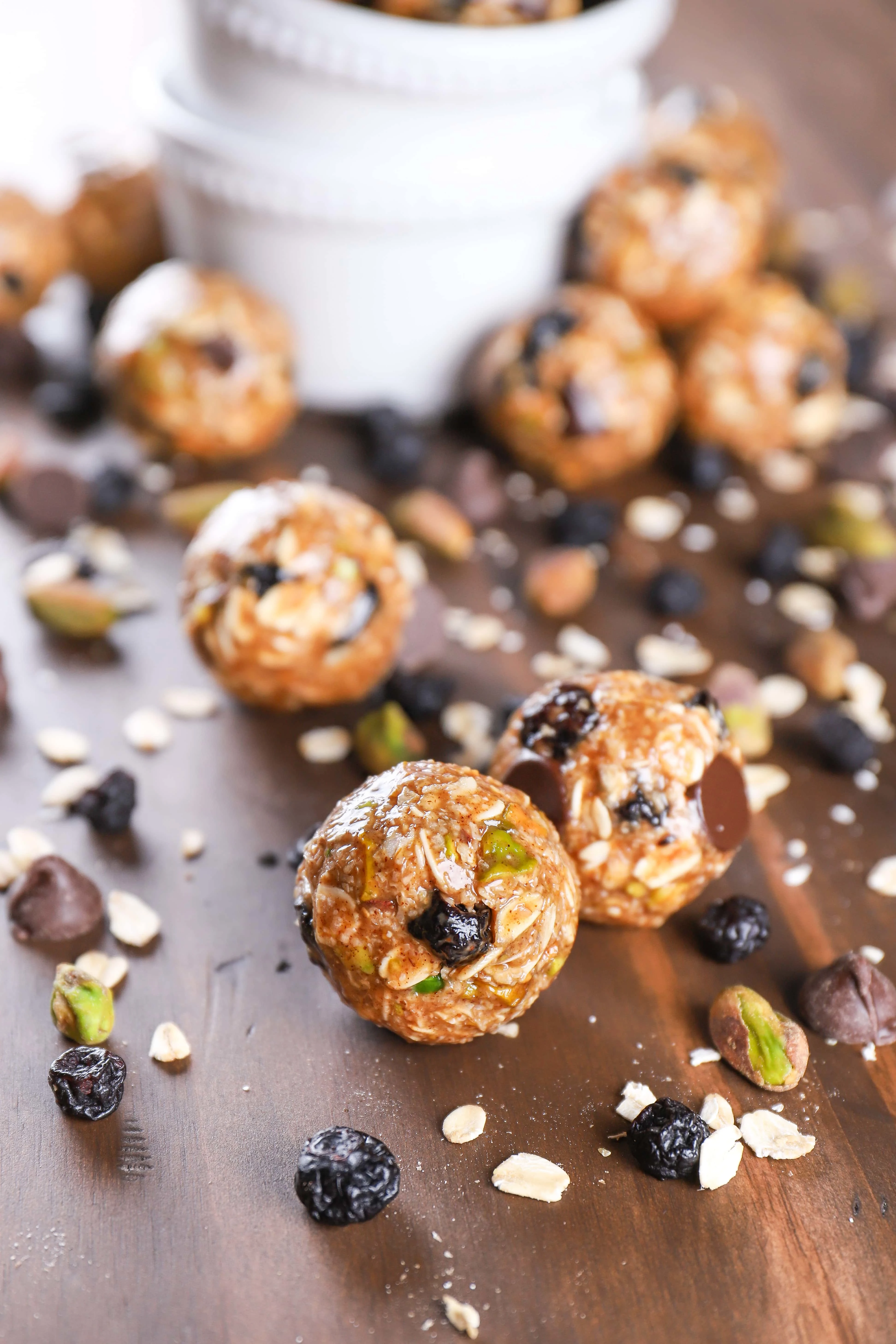a handful of dark chocolate blueberry pistachio granola bites on a table
