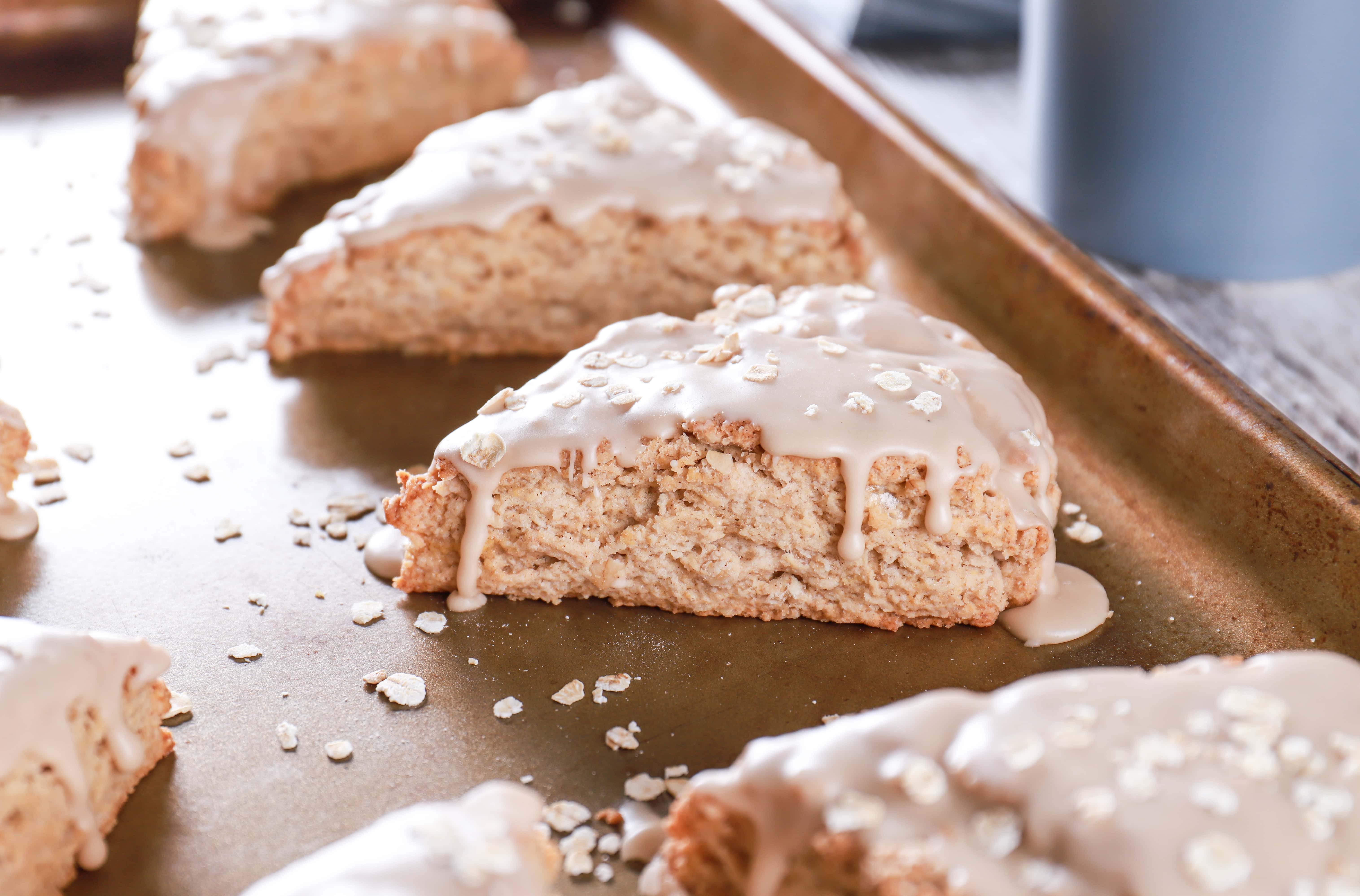 Up close image of a maple oat scone on a baking sheet. Recipe from A Kitchen Addiction