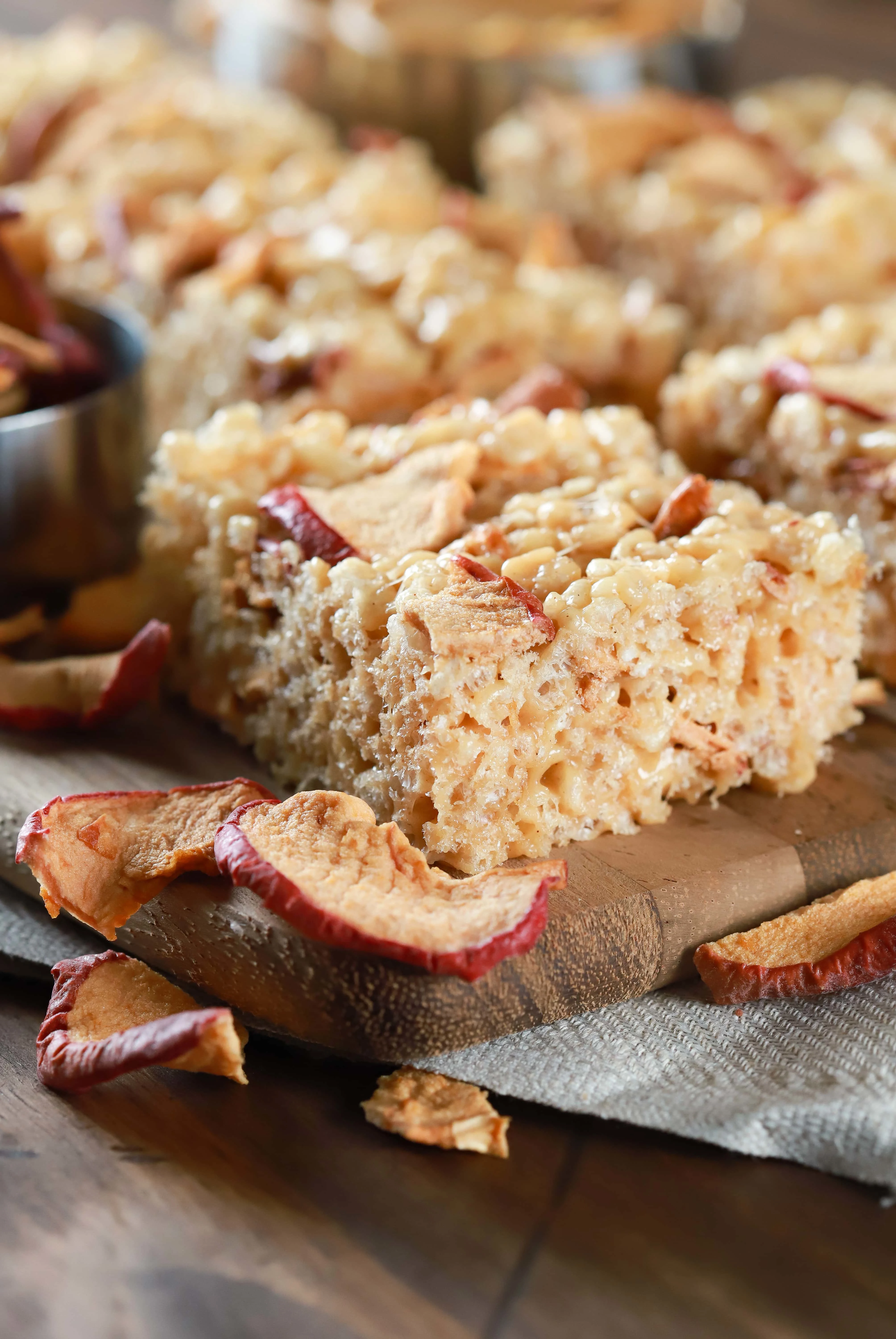 Easy apple peanut butter rice crispy treats on a cutting board. Recipe from A Kitchen Addiction