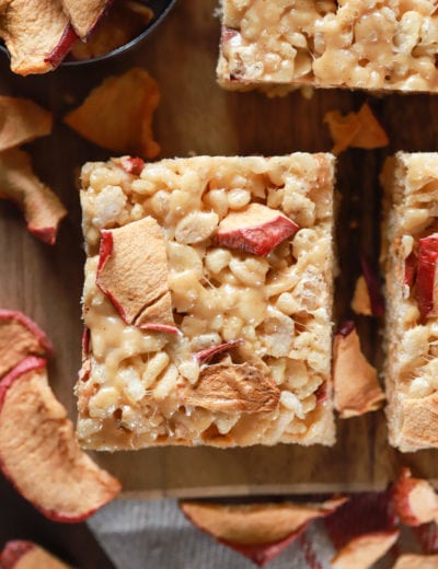 Up close overhead view of an apple peanut butter rice crispy treat on a cutting board. Recipe from A Kitchen Addiction