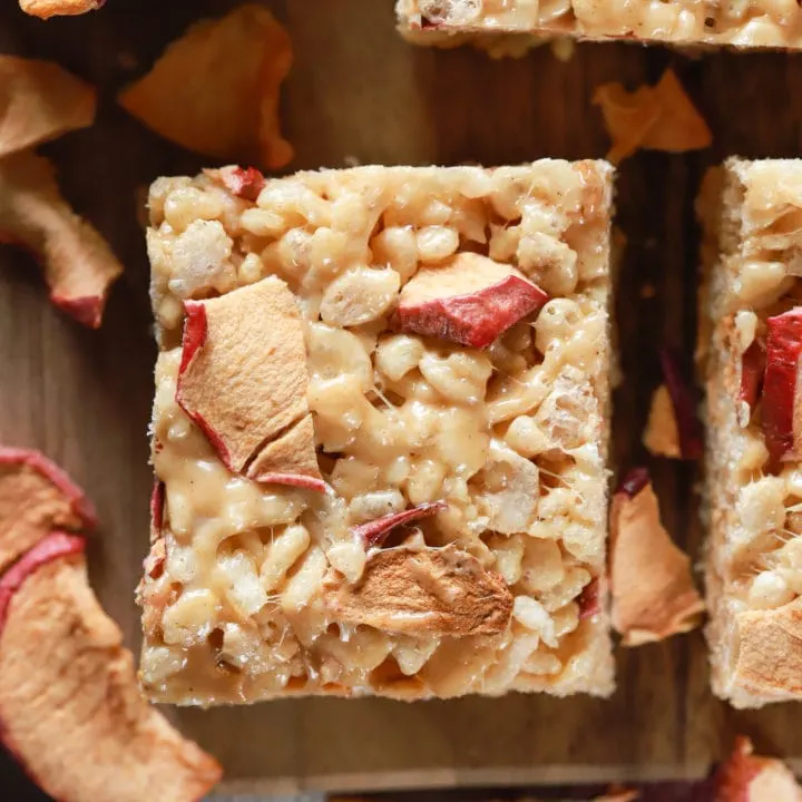 Up close overhead view of an apple peanut butter rice crispy treat on a cutting board. Recipe from A Kitchen Addiction