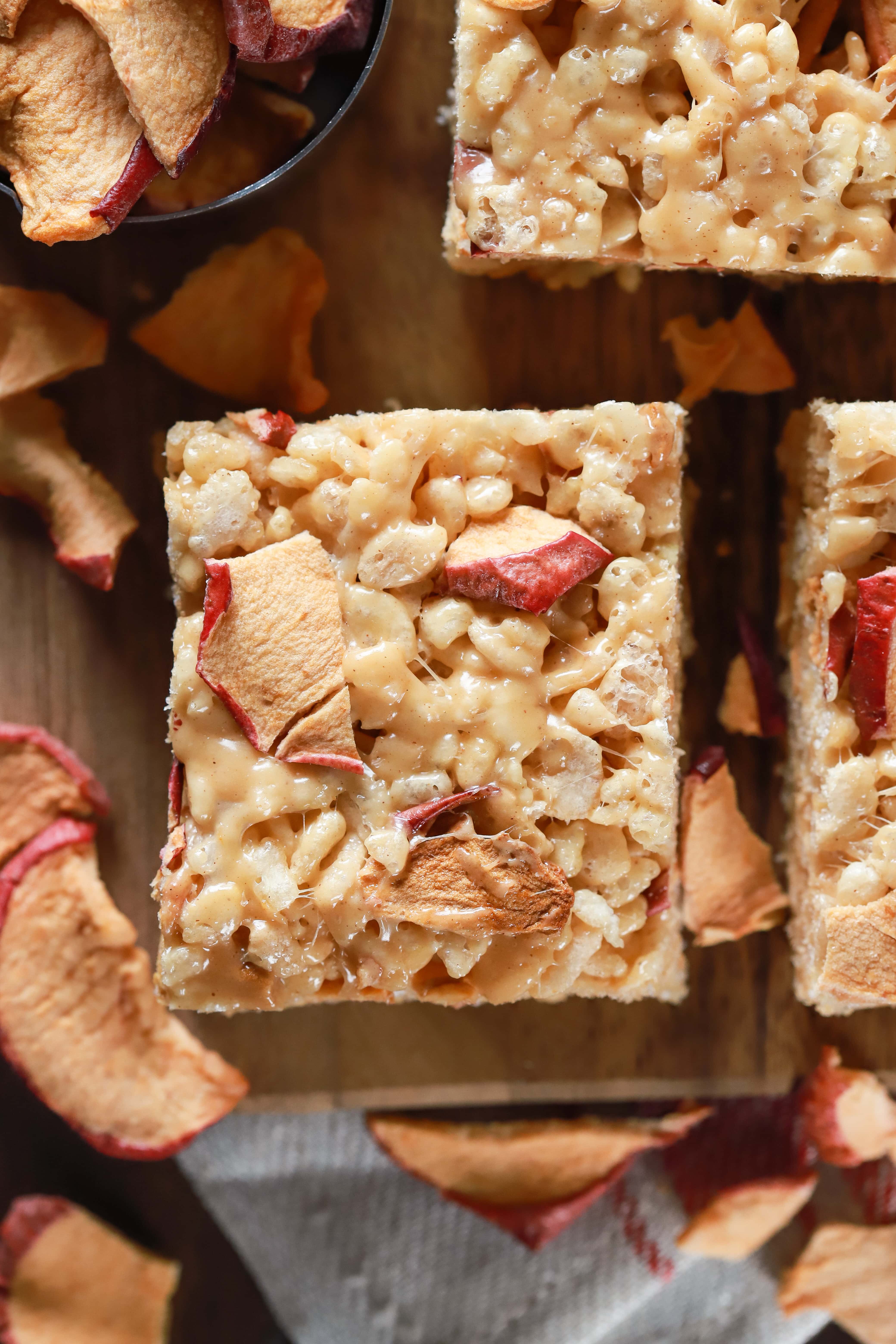 Up close overhead view of an apple peanut butter rice crispy treat on a cutting board. Recipe from A Kitchen Addiction