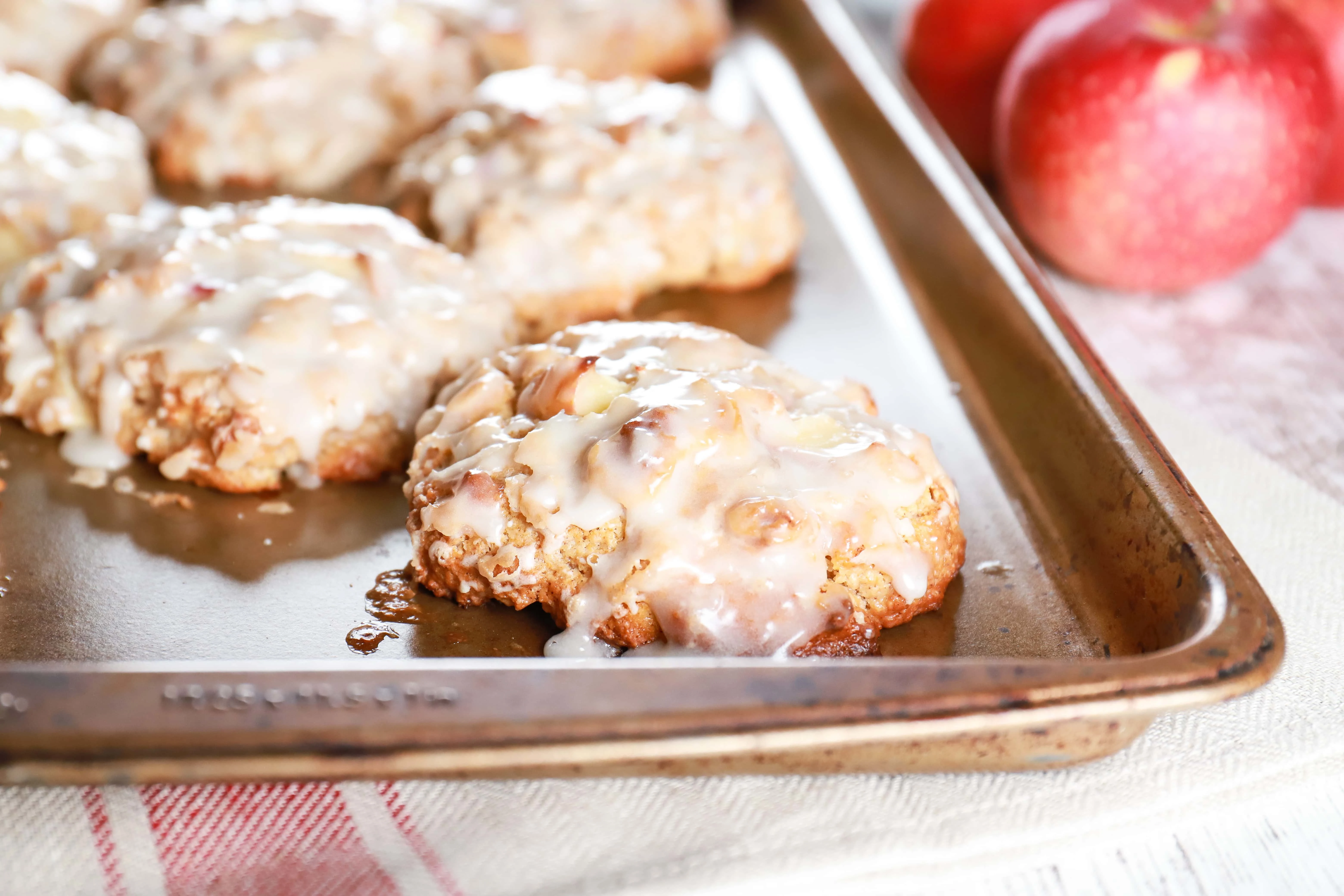 Up close image of a baked apple fritter on a cookie sheet. Recipe from A Kitchen Addiction