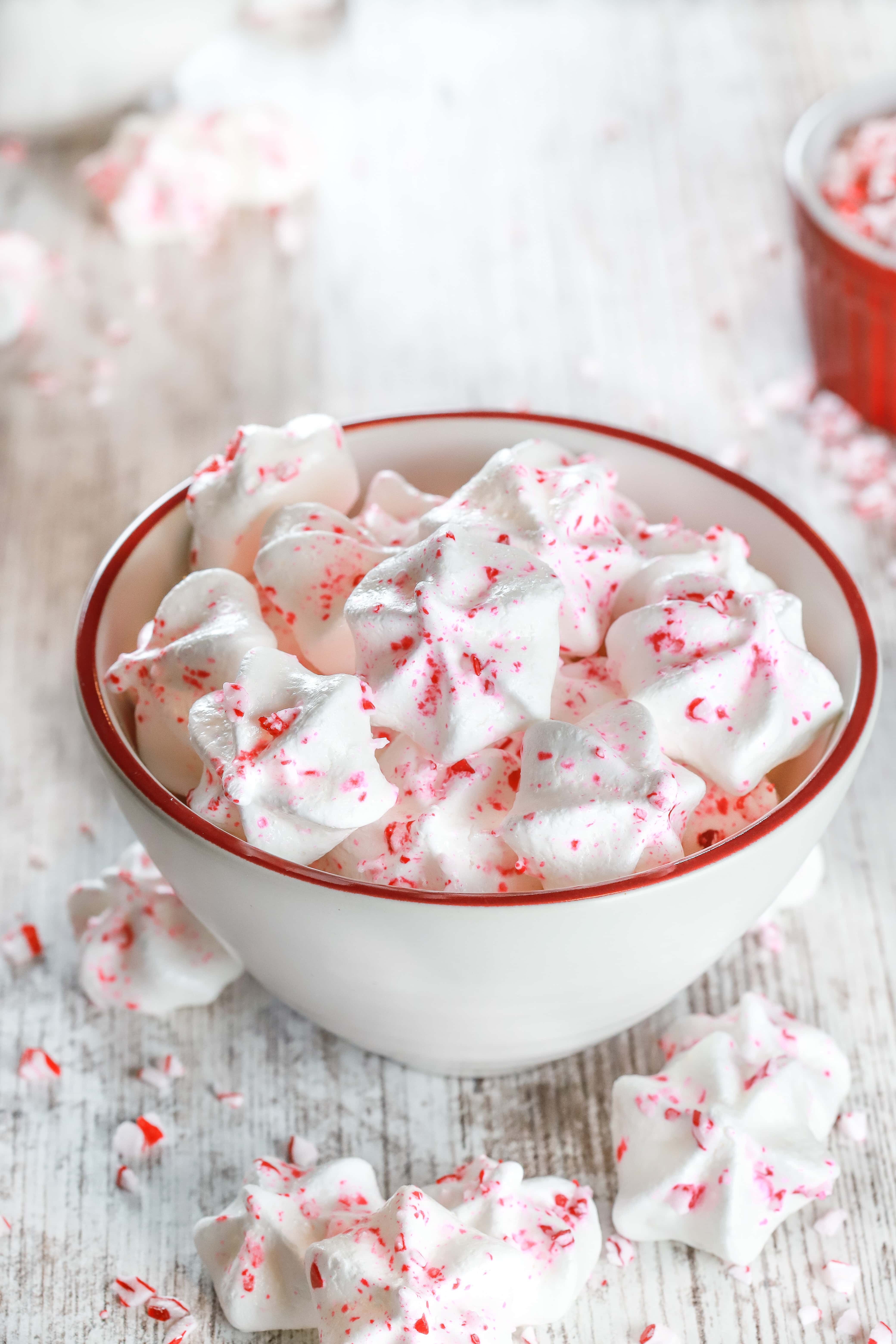 Small white bowl full of Mini Peppermint Meringue Cookies. Recipe from A Kitchen Addiction
