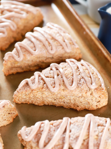 Up close image of Banana Snickerdoodle Scones on a baking sheet. Recipe for scones from A Kitchen Addiction