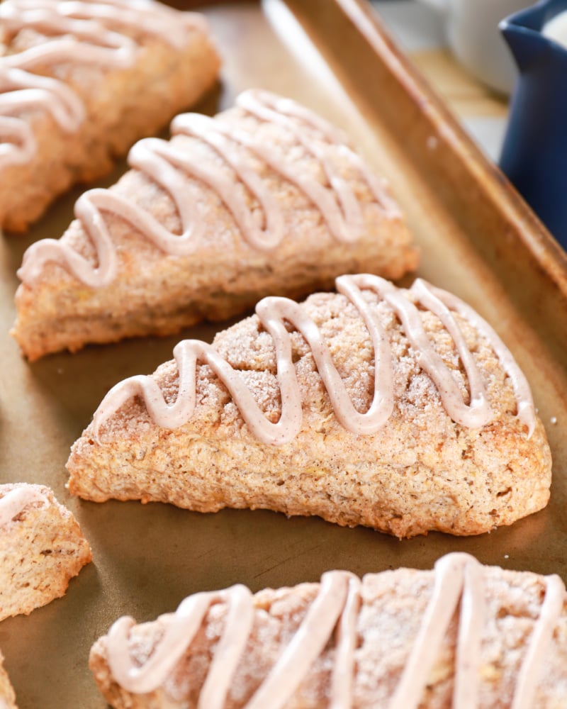 Up close image of Banana Snickerdoodle Scones on a baking sheet. Recipe for scones from A Kitchen Addiction