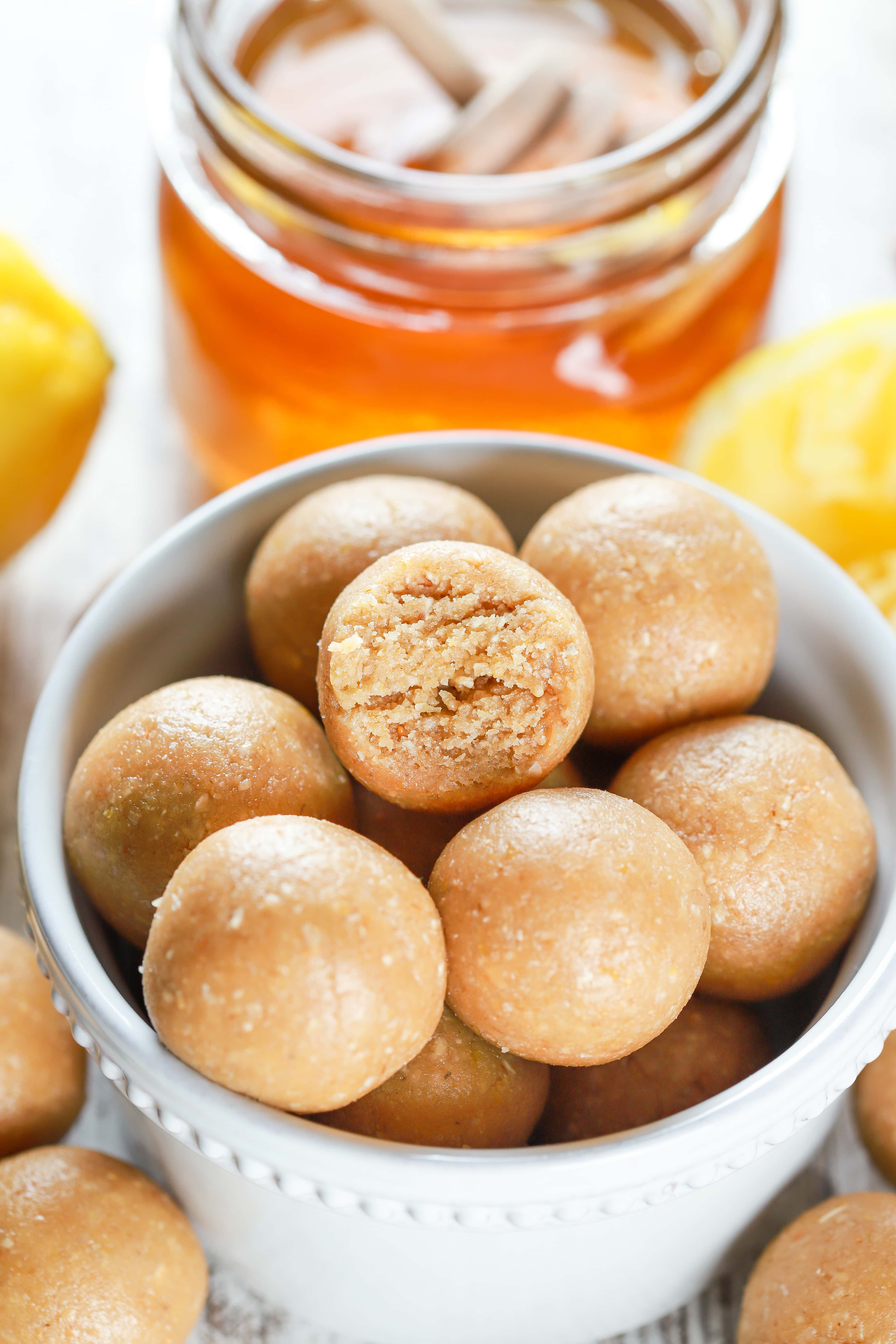 Up close image of a lemon protein bite with a bite taken out of it. Recipe from A Kitchen Addiction