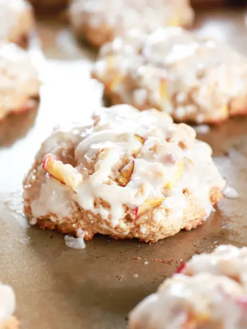 Baked peach fritters on a cookie sheet.