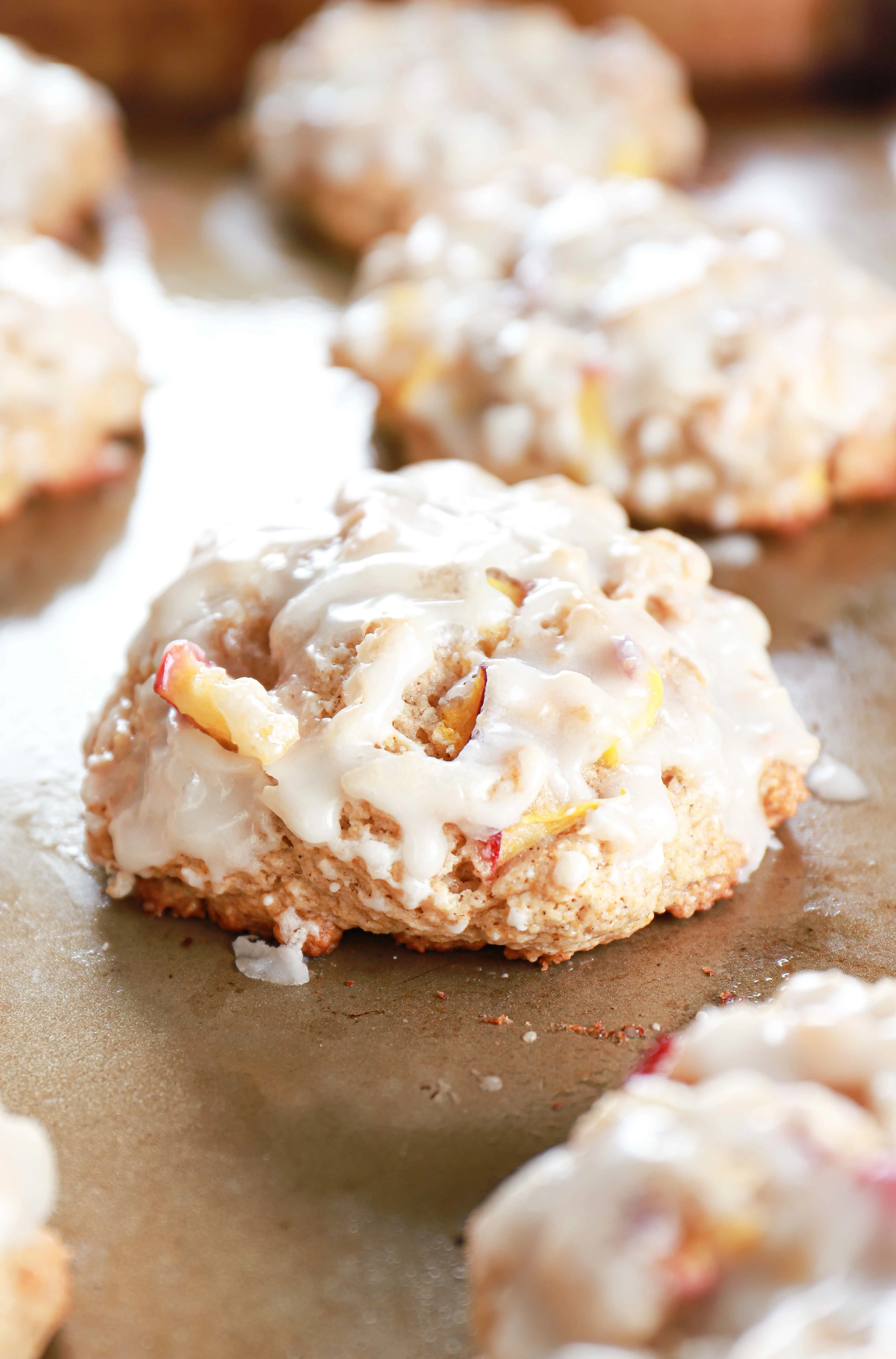 Baked peach fritters on a cookie sheet.