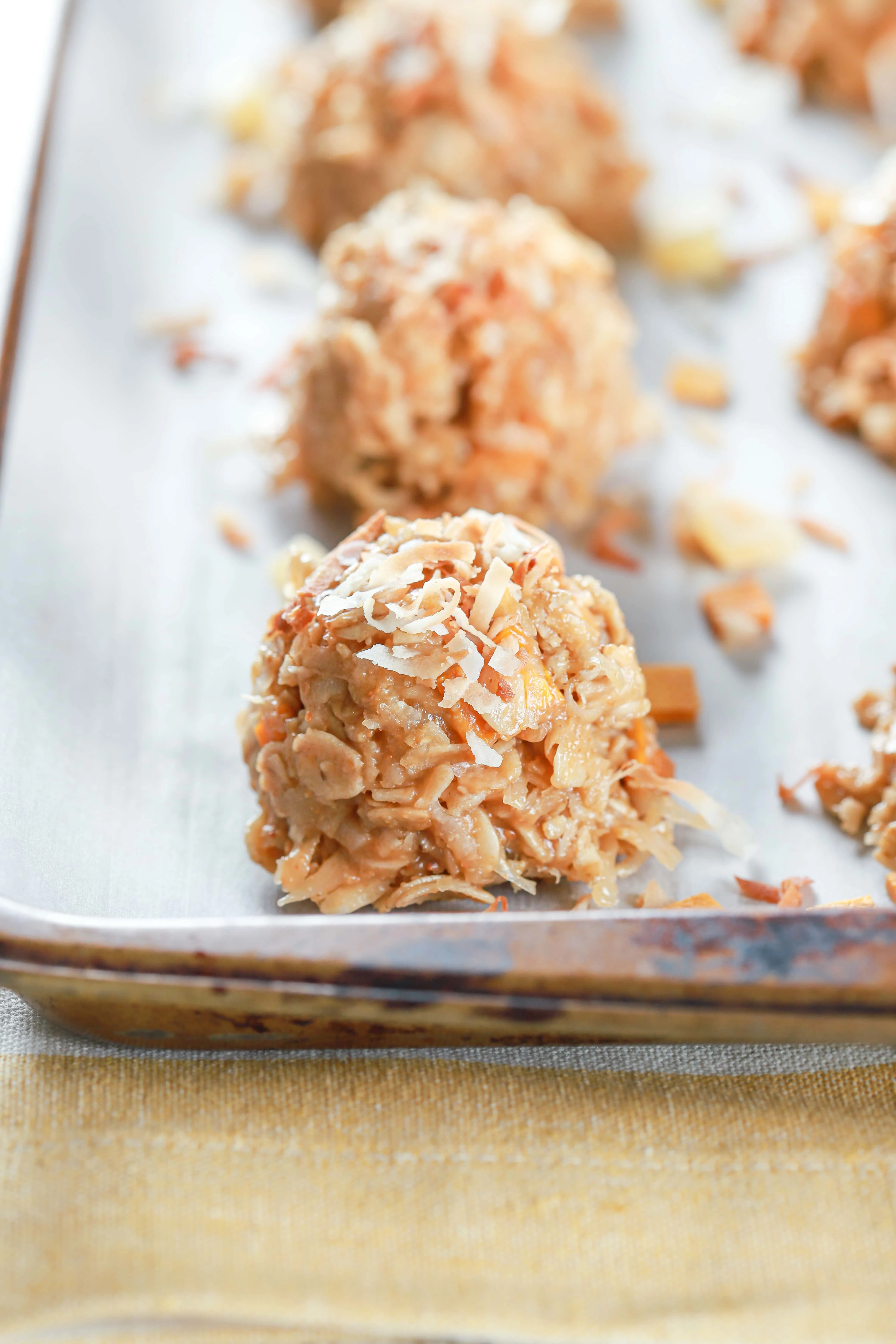 Side view of a tropical no bake cookie filled with pineapple, mango, and coconut