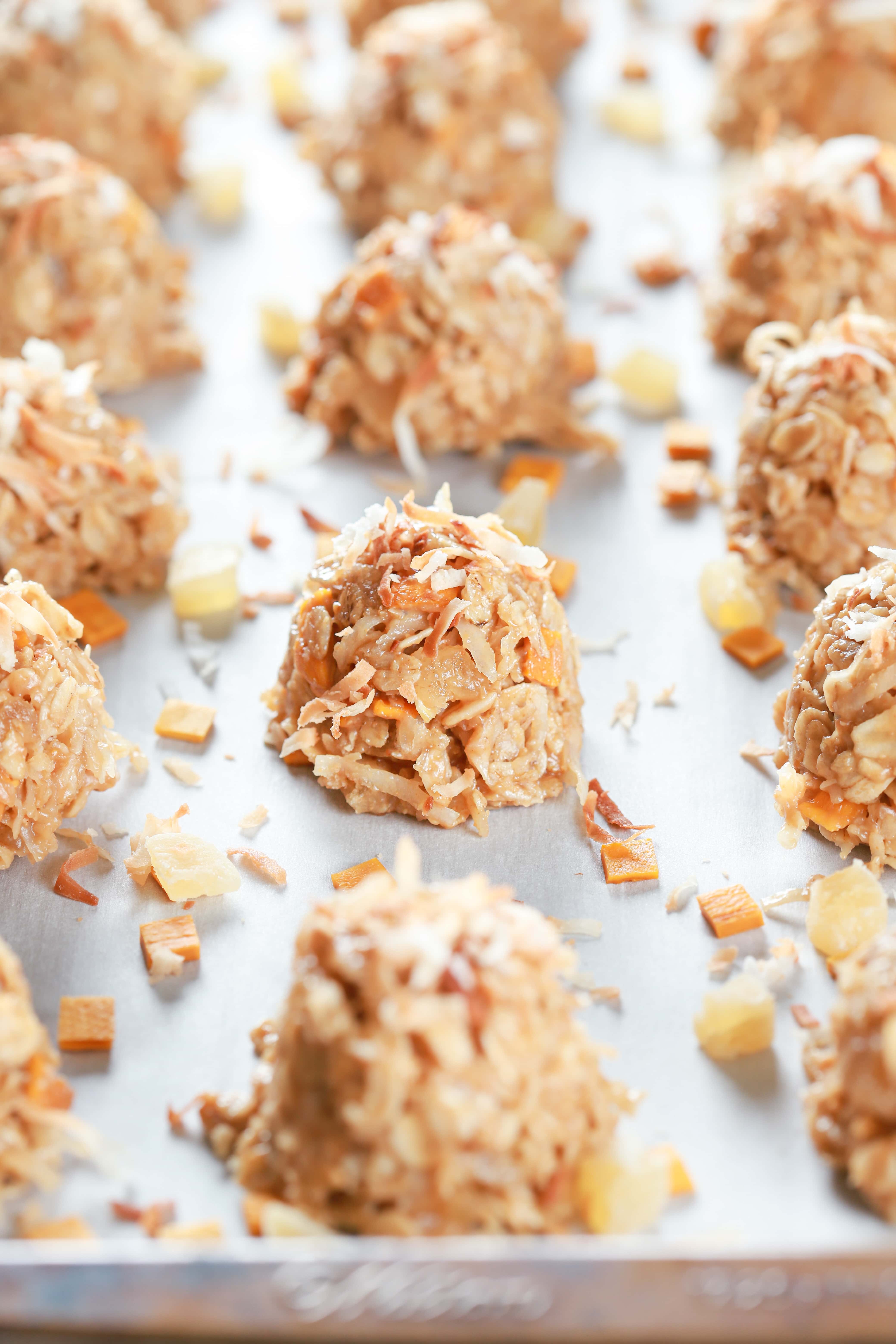 Tropical no bake cookies on a parchment paper lined baking sheet. Recipe for cookies from A Kitchen Addiction