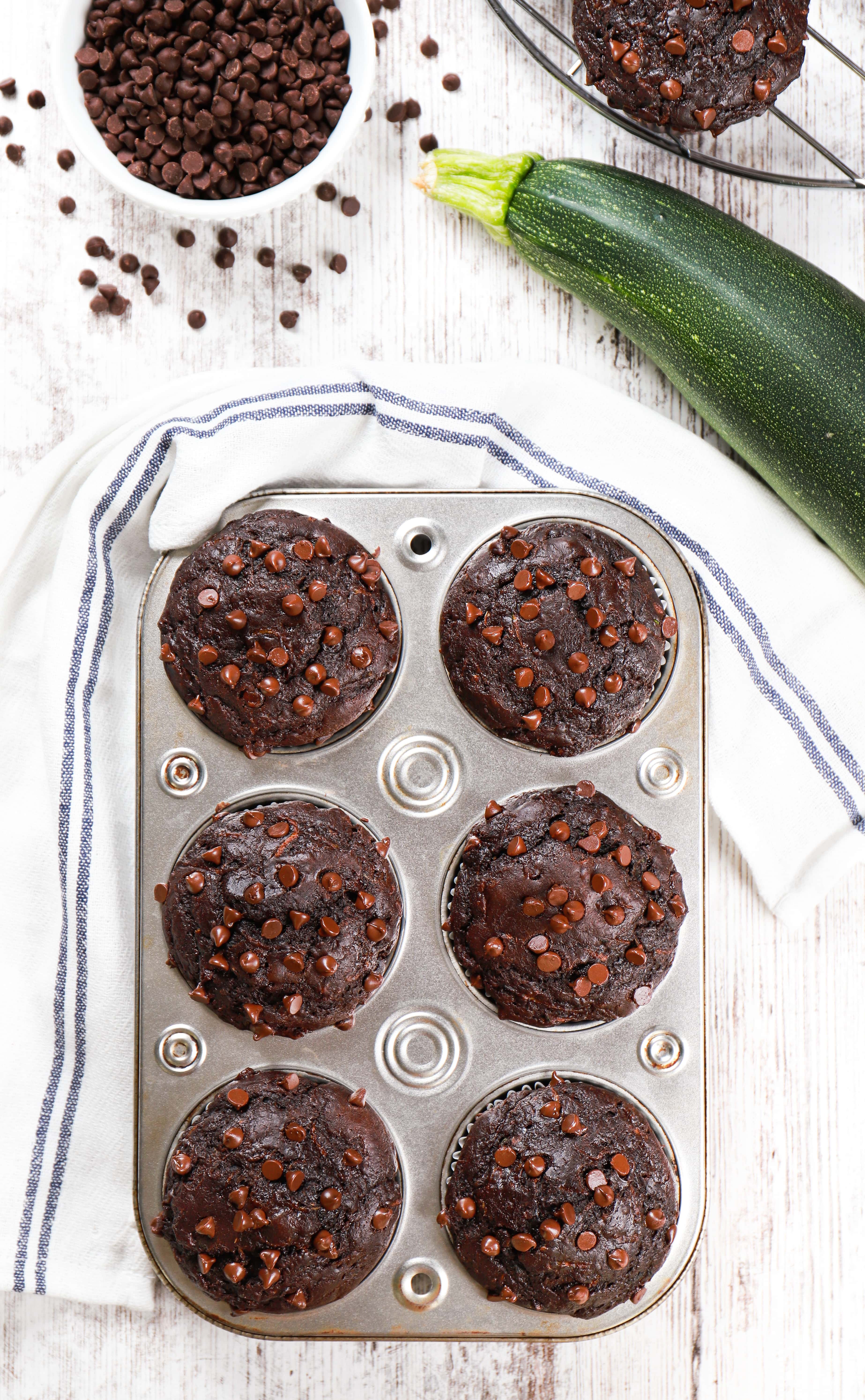 Above view of a muffin tin full of bakery style double chocolate zucchini muffins. Recipe from A Kitchen Addiction