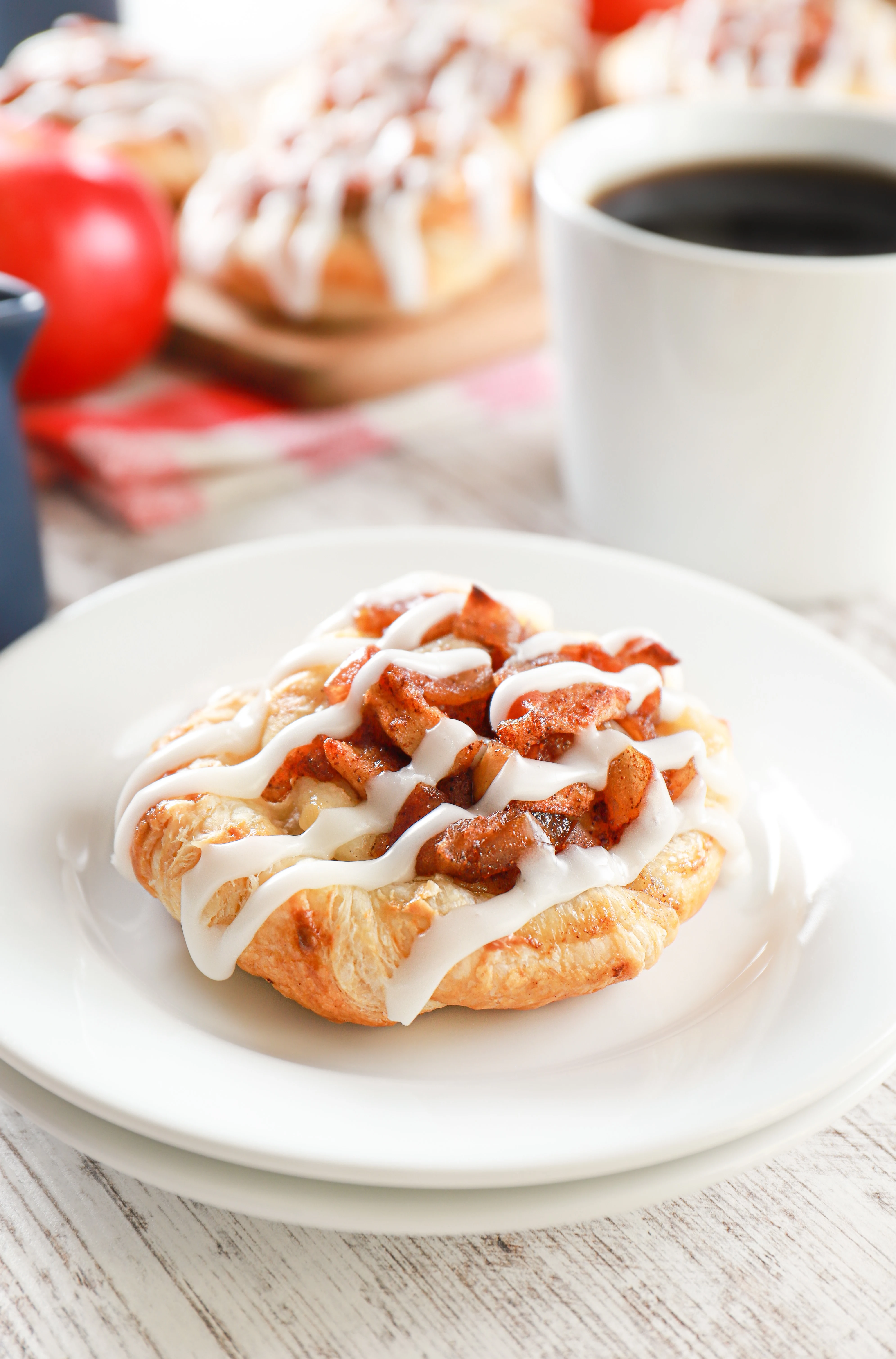 puff pastry apple cream cheese danish on a small white plate